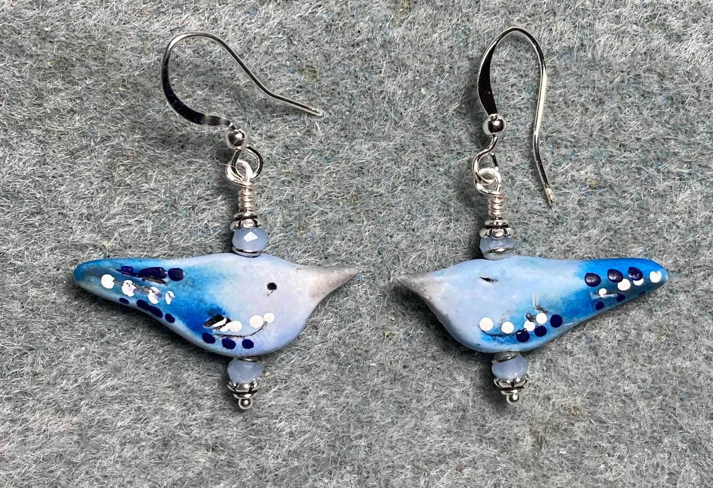 Small light and dark blue polymer clay bird bead earrings adorned with light blue Chinese crystal beads.