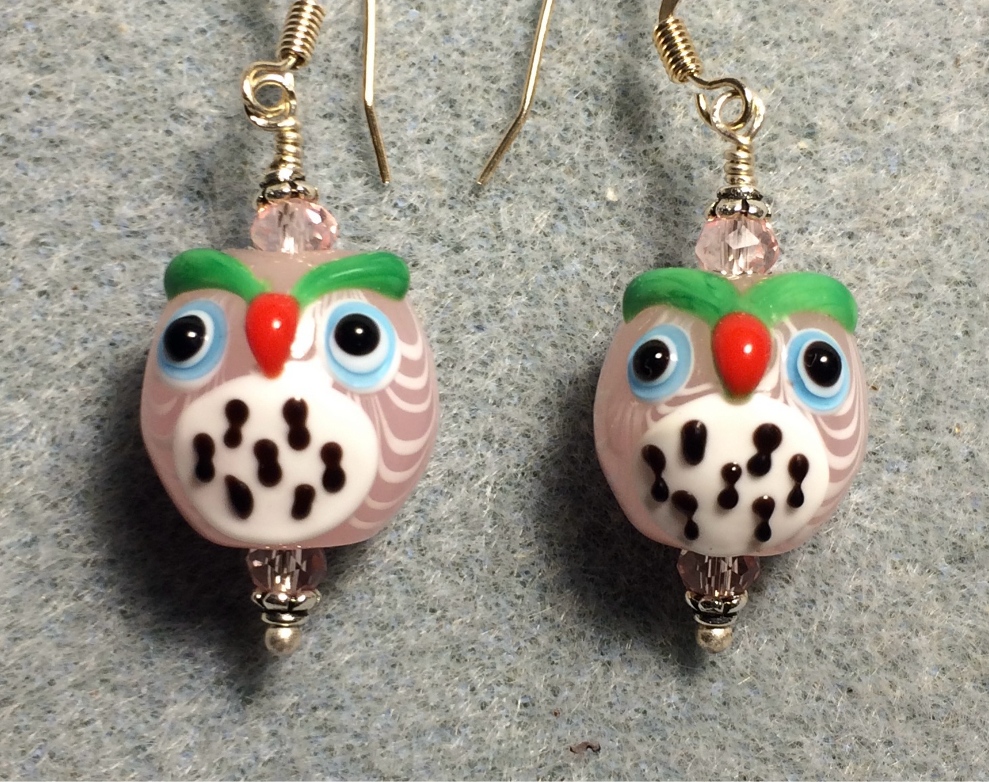 Light pink and white lamp work spotted owl bead earrings adorned with pink Chinese crystal beads.