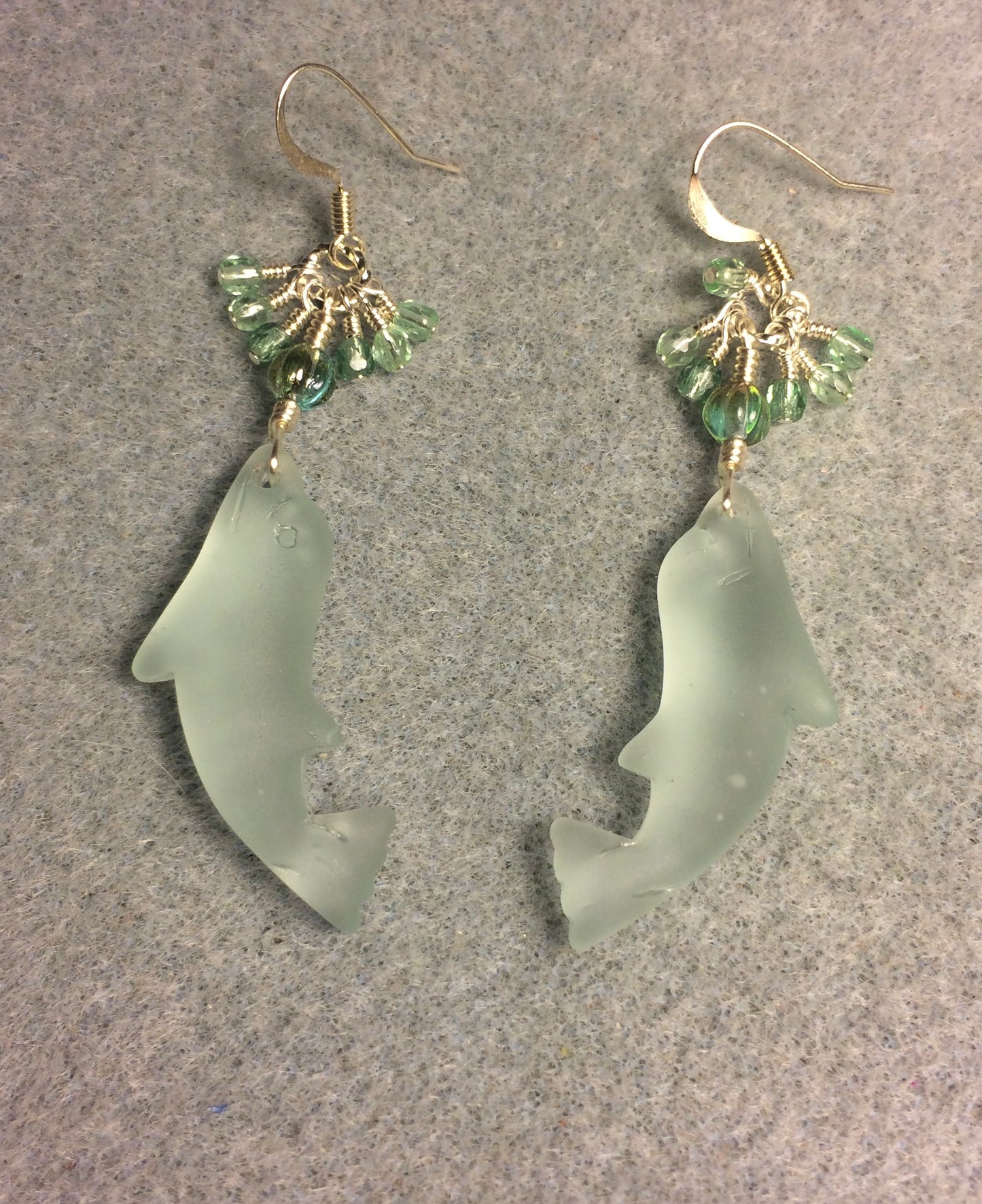 Light green sea glass dolphin pendant bead earrings adorned with light green Czech glass beads and tiny dangling light green Czech glass beads.