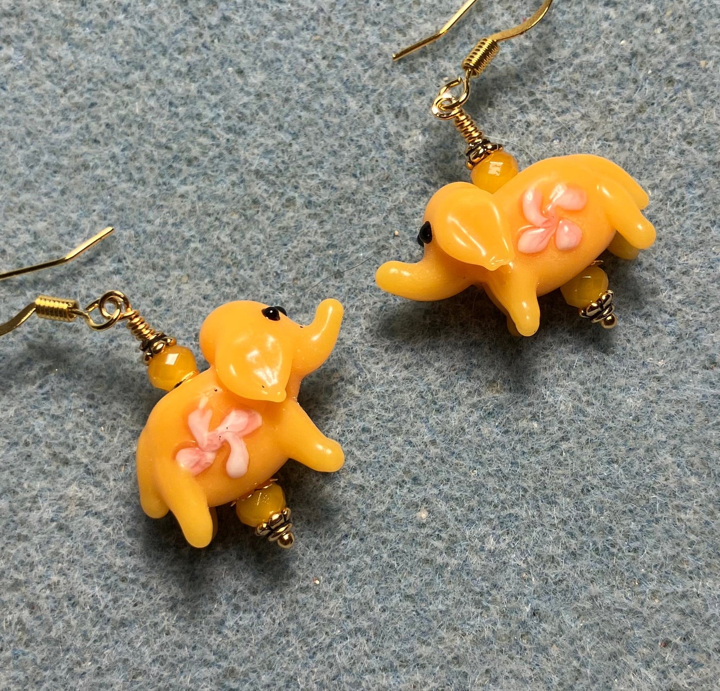 Yellow amber lamp work elephant bead earrings adorned with yellow Chinese crystal beads.