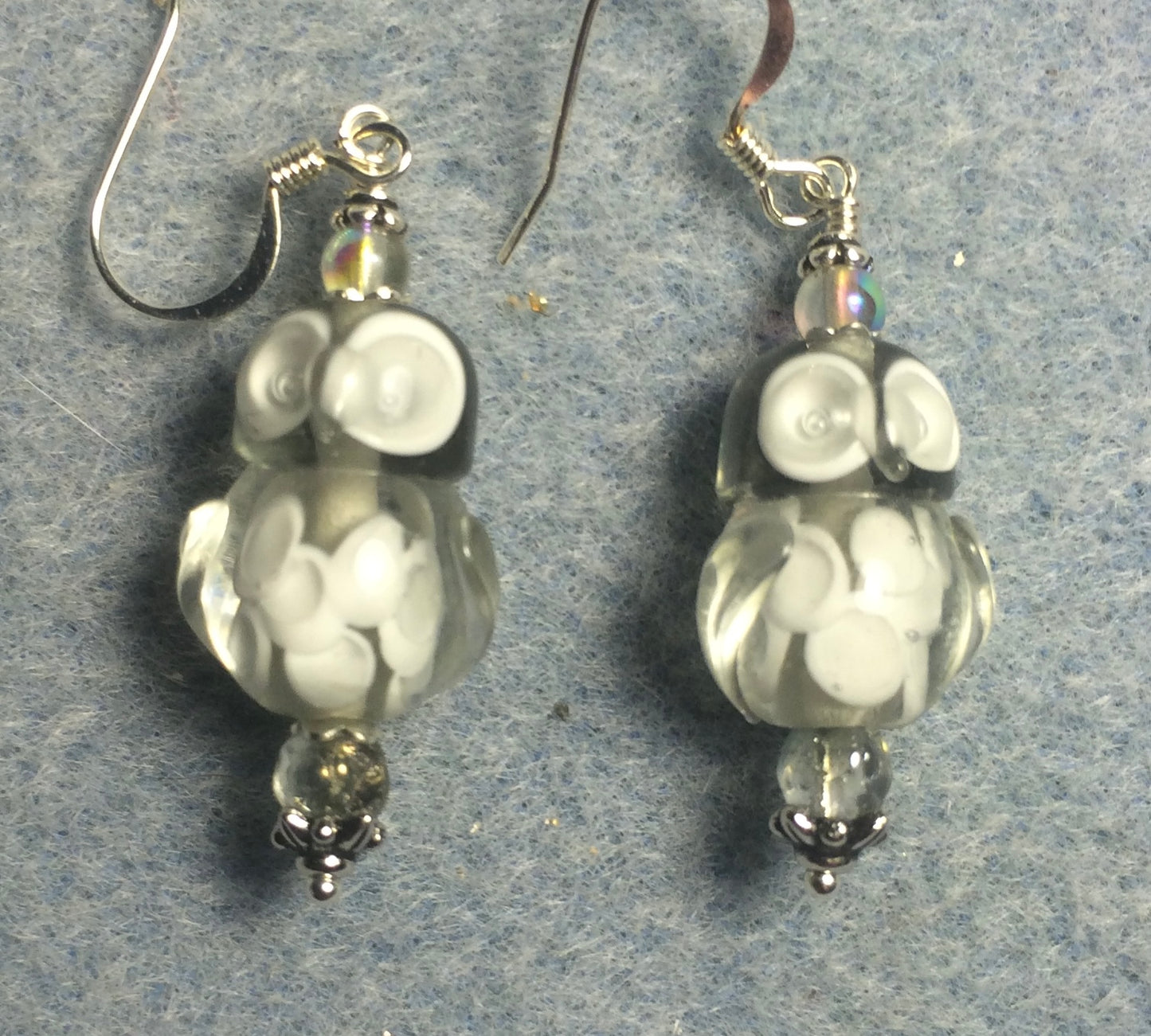 Gray lamp work owl bead earrings adorned with clear Czech glass beads.