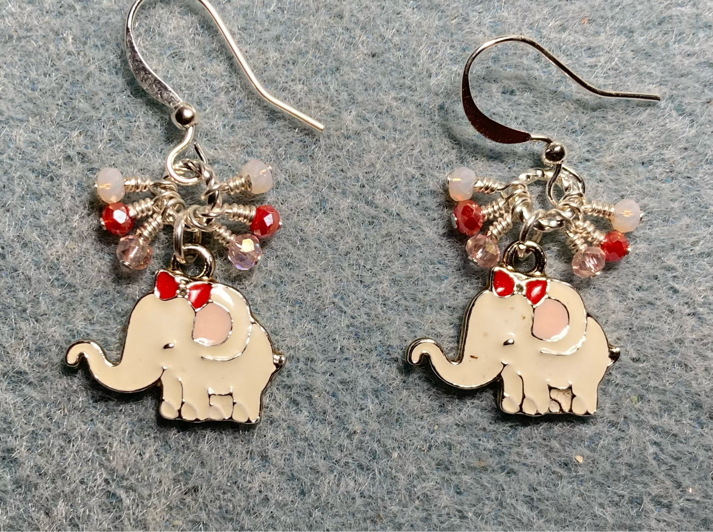 White, red, and pink enamel elephant charm earrings adorned with tiny dangling white, red, and pink Chinese crystal beads.