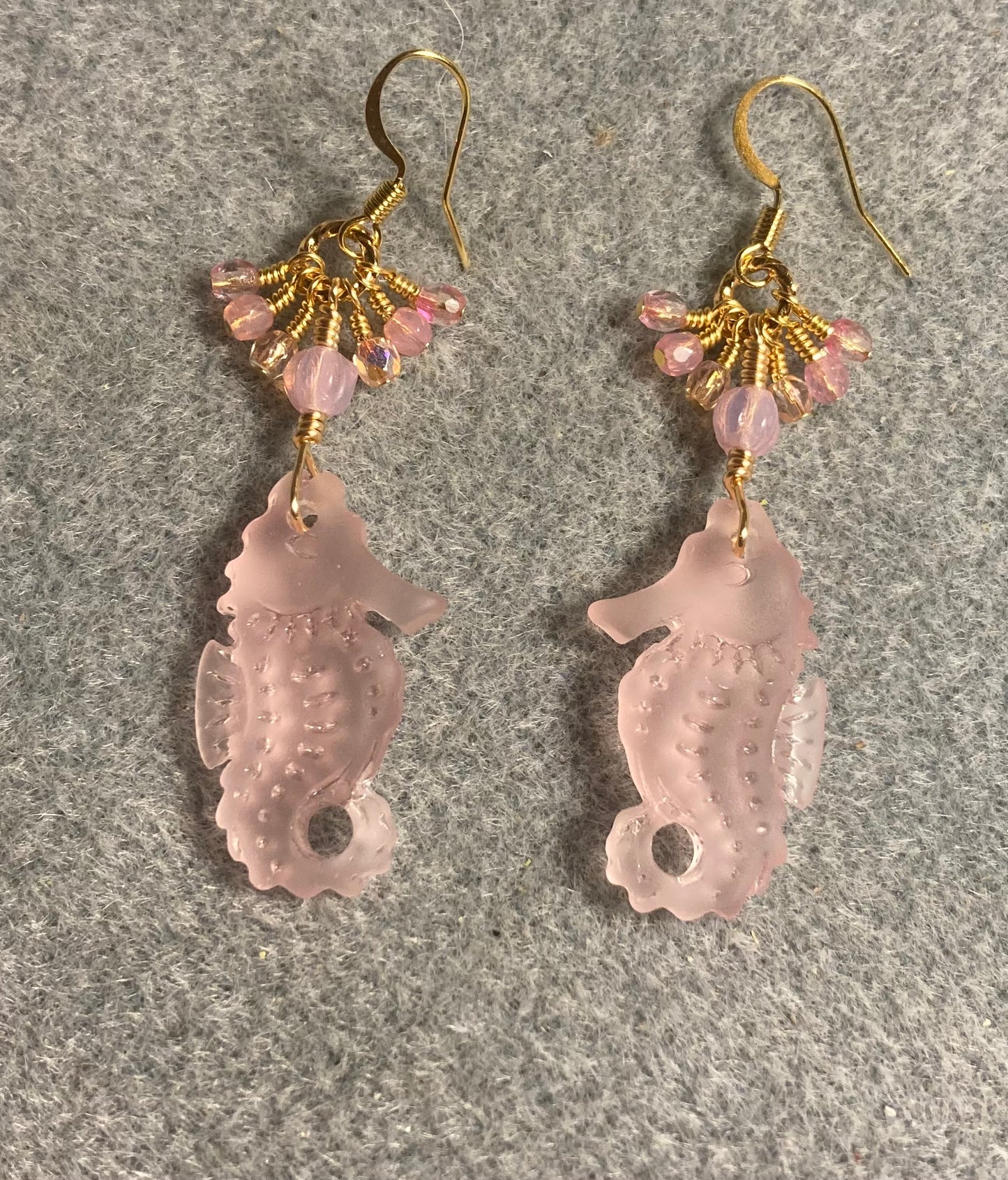 Pink sea glass seahorse pendant bead earrings adorned with pink Czech glass beads and tiny dangling pink Czech glass beads.