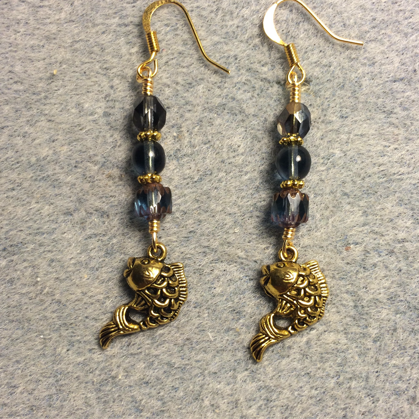 Gold fish charm earrings adorned with Montana blue Czech glass beads