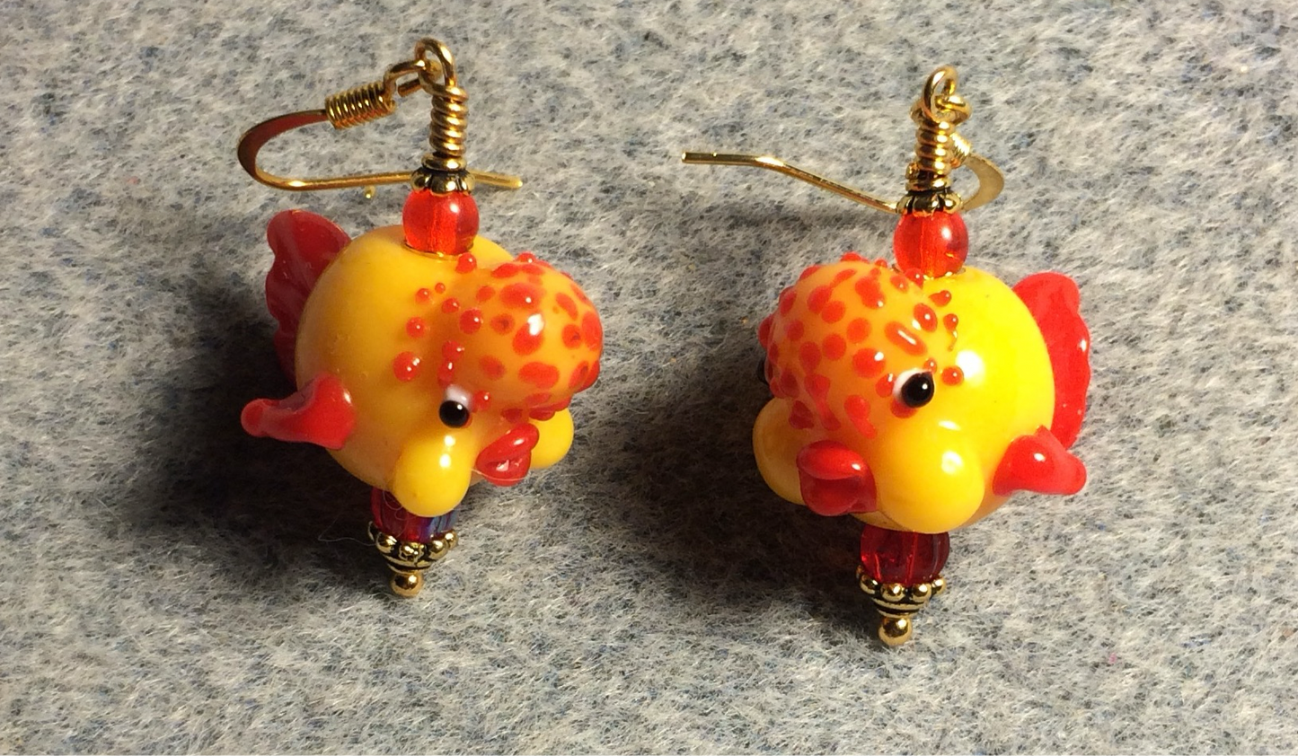 Opaque yellow and red lamp work clownfish bead earrings adorned with red Czech glass beads.