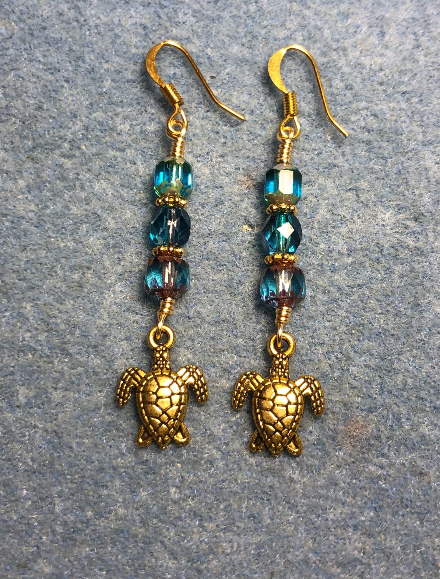 Gold sea turtle charm earrings adorned with turquoise Czech glass beads