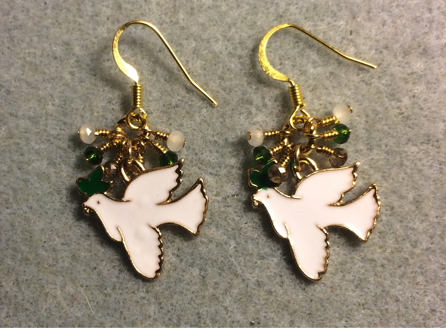 White, green, and gold enamel dove charm earrings adorned with tiny dangling white, green, and gold Chinese crystal beads.