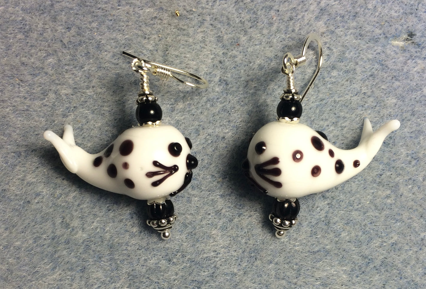 Black and white lamp work spotted whale bead earrings adorned with black Czech glass beads.