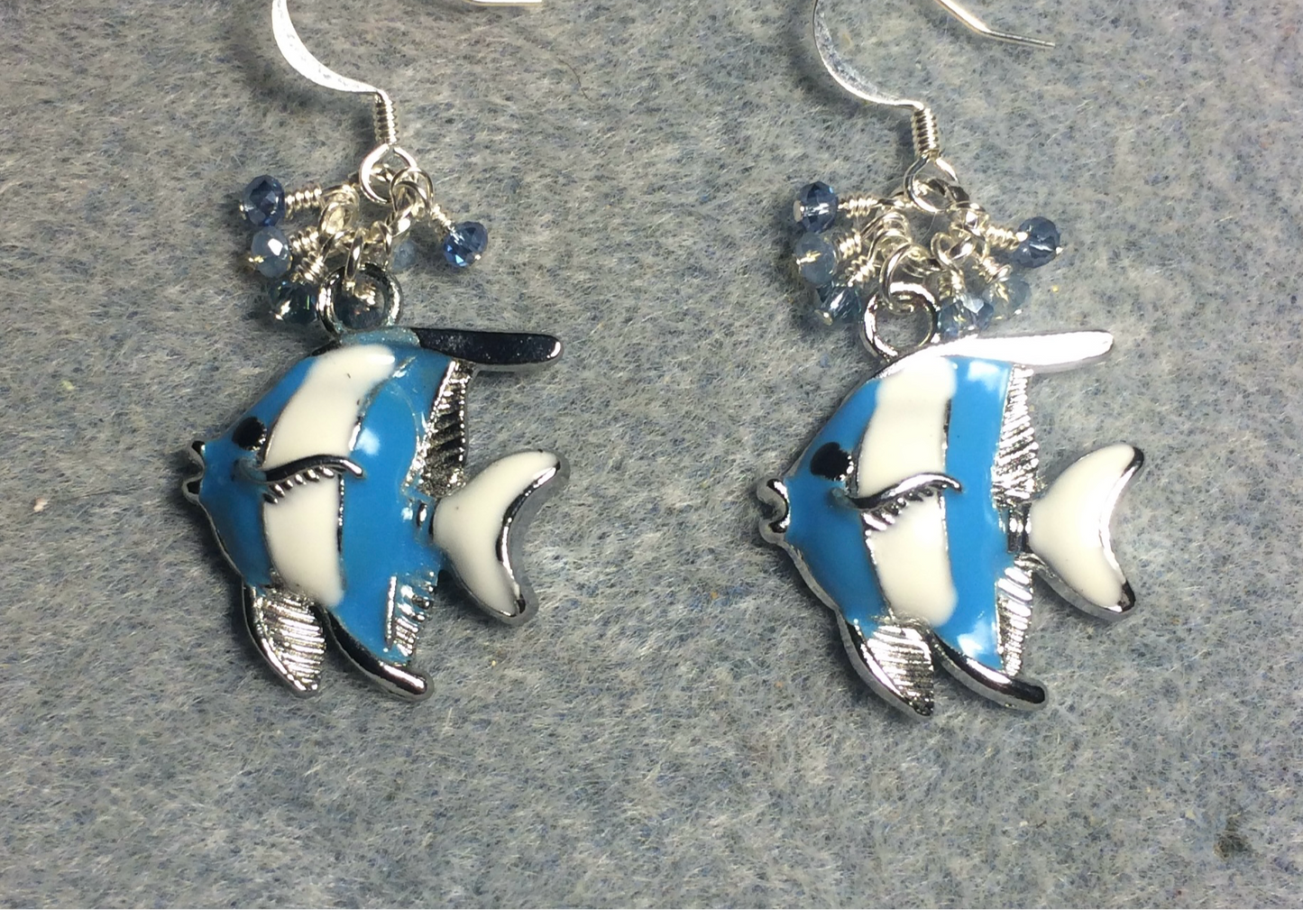 Light blue and white enamel striped angelfish charm earrings adorned with tiny dangling light blue Chinese crystal beads.