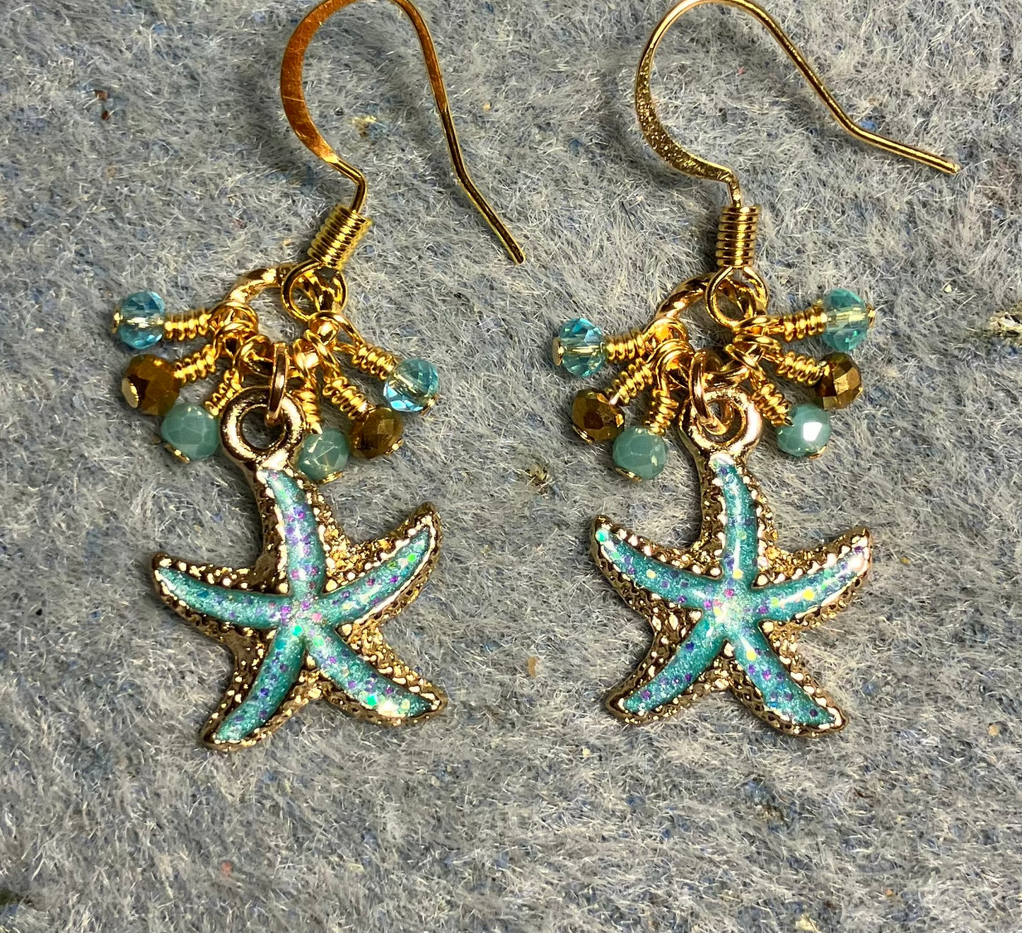 Aqua and gold enamel starfish charm earrings adorned with tiny dangling aqua and gold Chinese crystal beads.