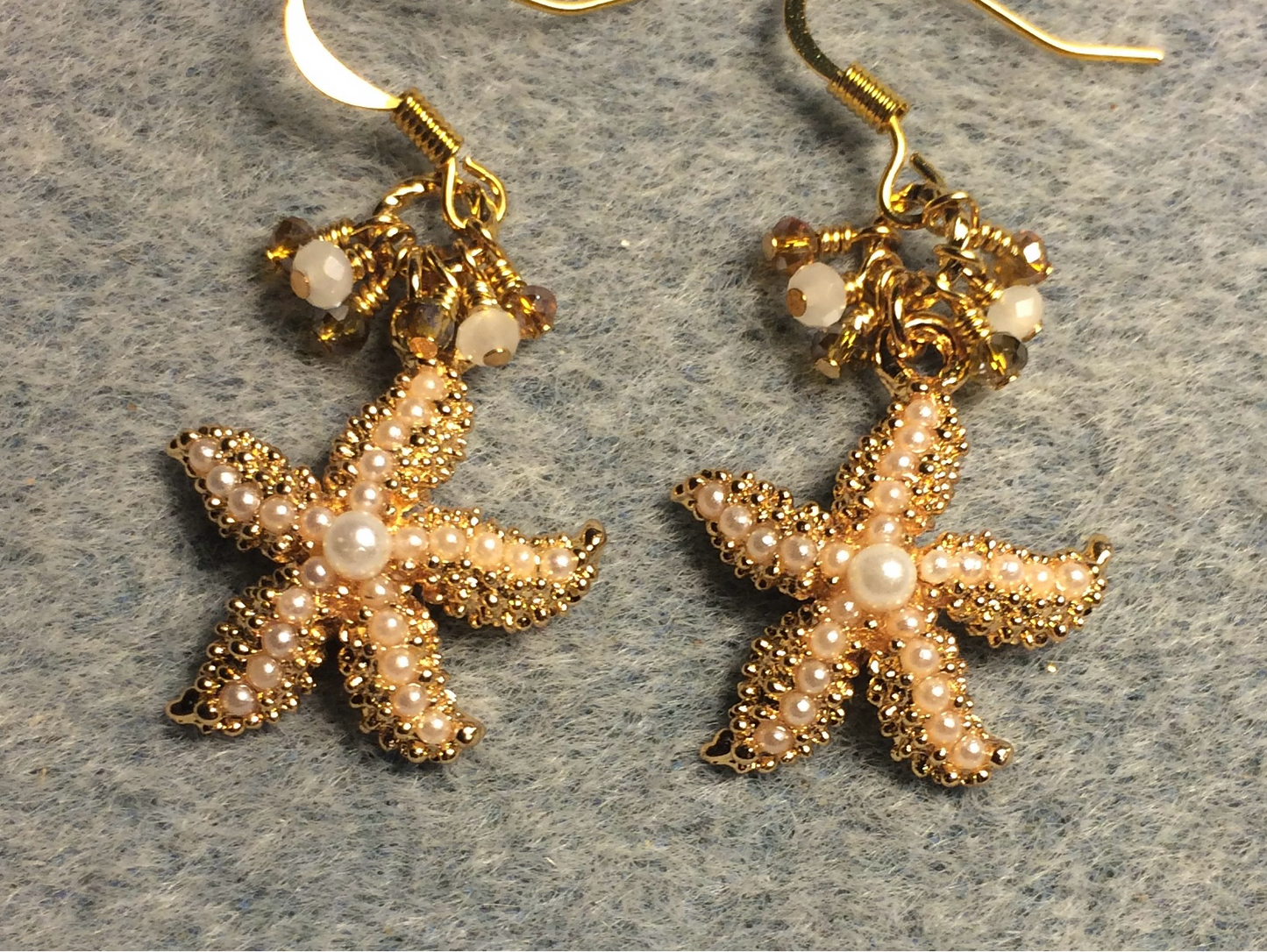 Gold and pearl starfish charm earrings adorned with tiny dangling amber and white Chinese crystal beads.