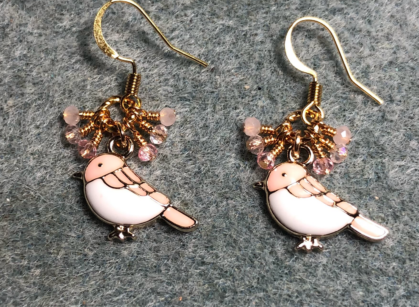 Small pink and white enamel songbird charm earrings adorned with tiny dangling pink and peach Chinese crystal beads.