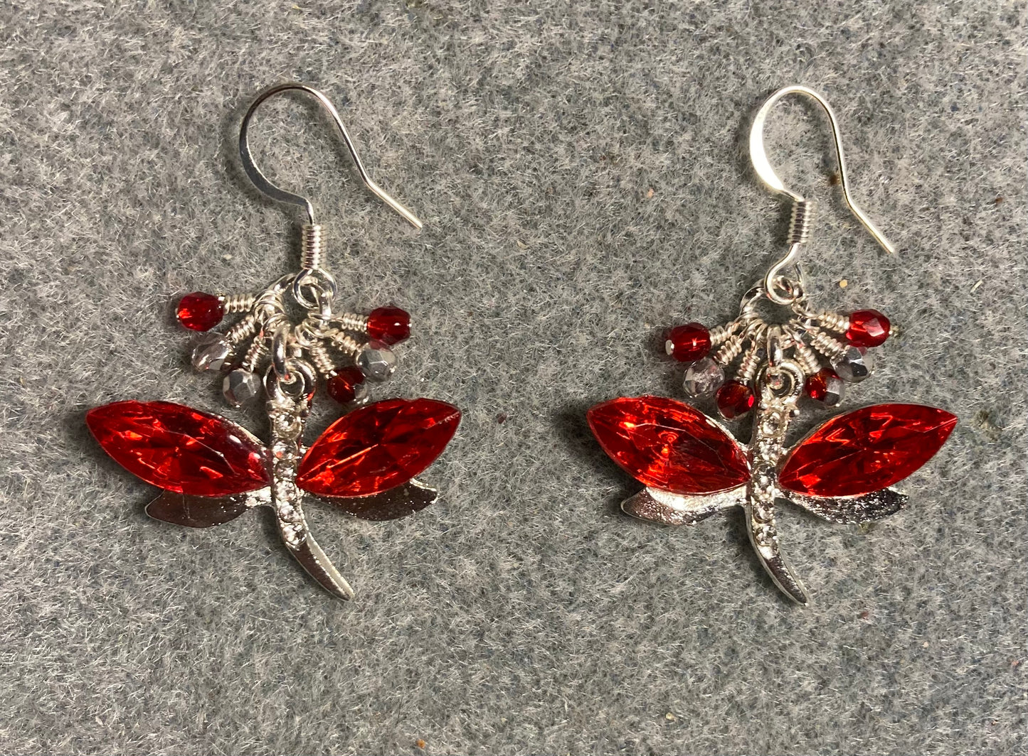Red and silver rhinestone dragonfly charm earrings adorned with small dangling red and silver Czech glass beads.