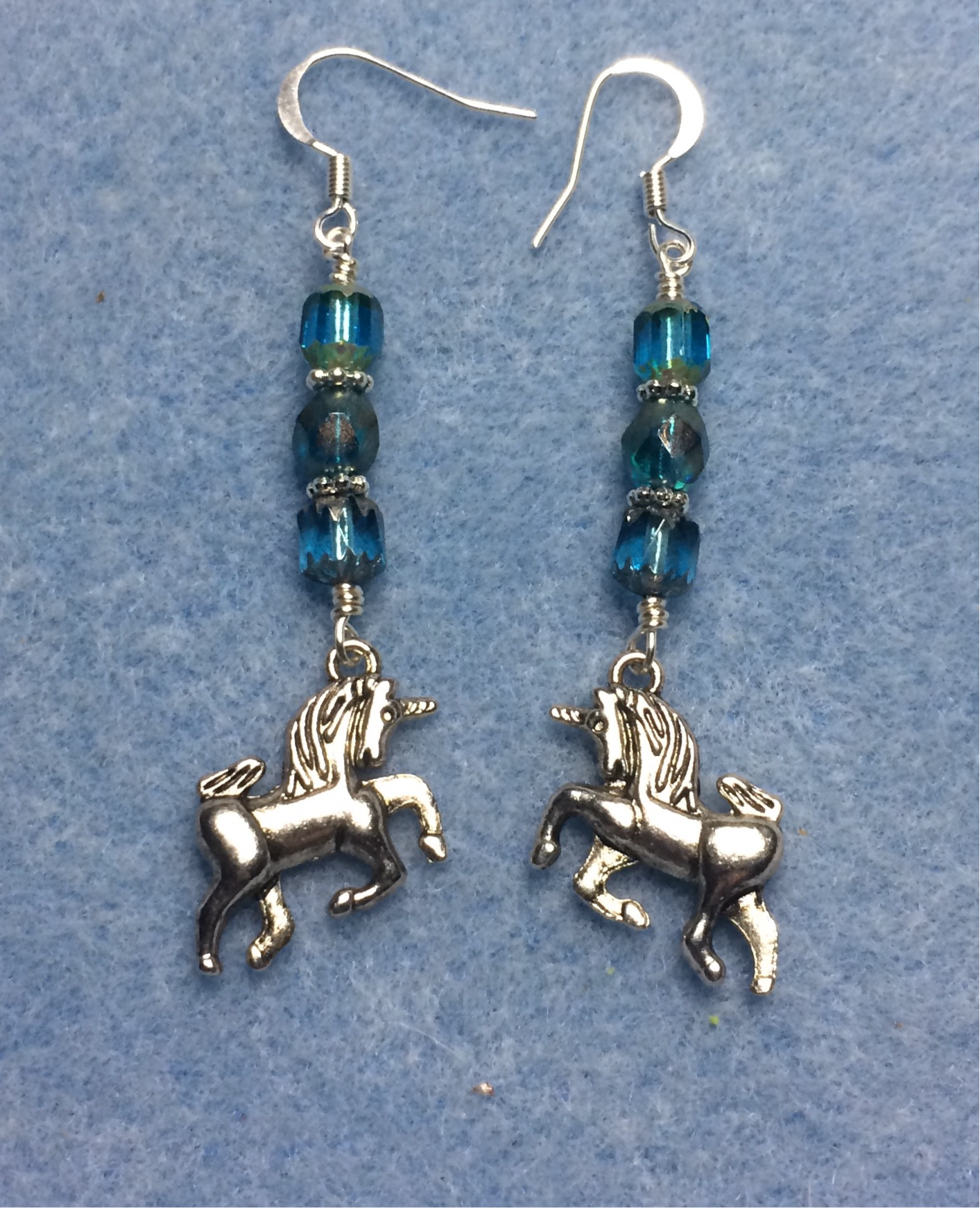 Silver unicorn charm earrings adorned with turquoise Czech glass beads