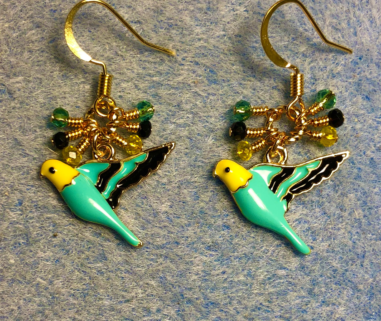 Turquoise, black, and yellow enamel parakeet charm earrings adorned with tiny dangling turquoise, black, and yellow Chinese crystal beads.