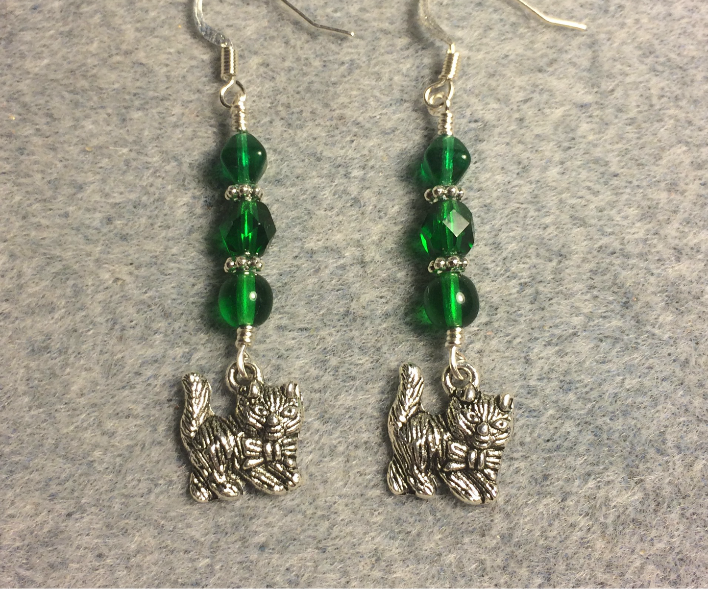 Silver cat charm earrings adorned with emerald green Czech glass beads