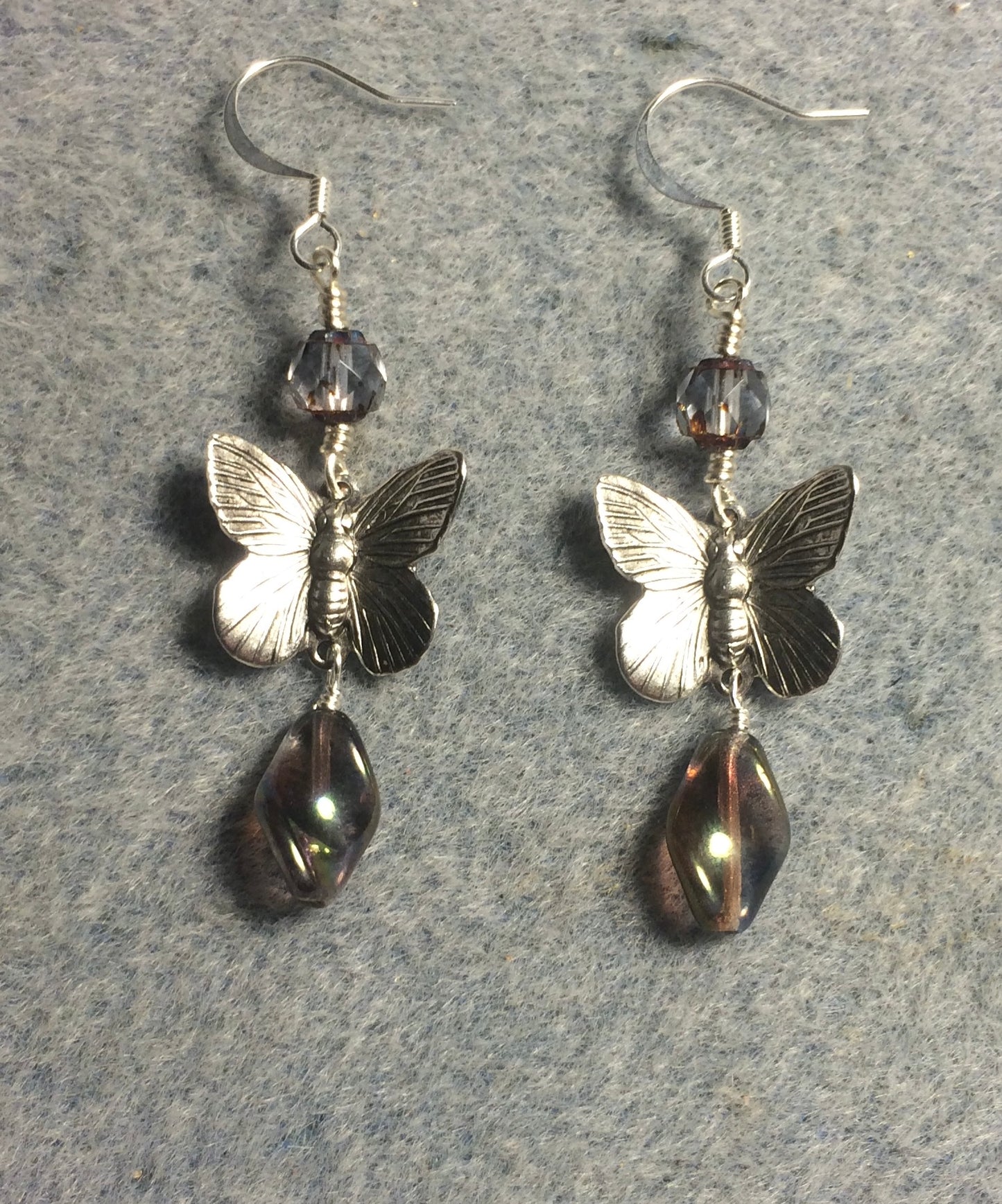 Silver butterfly charm connector earrings adorned with smoky blue gray Czech glass twist beads and smoky blue gray Czech glass beads.