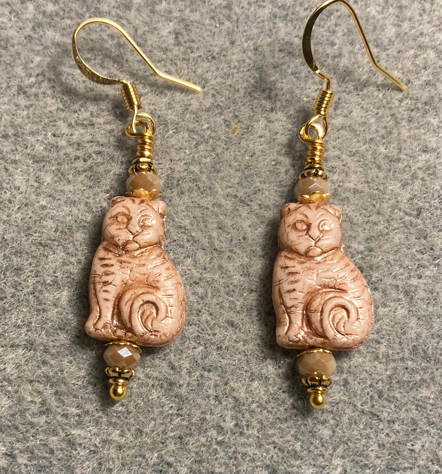 Medium beige (with gold inlay) Czech glass cat bead earrings adorned with beige Chinese crystal beads.