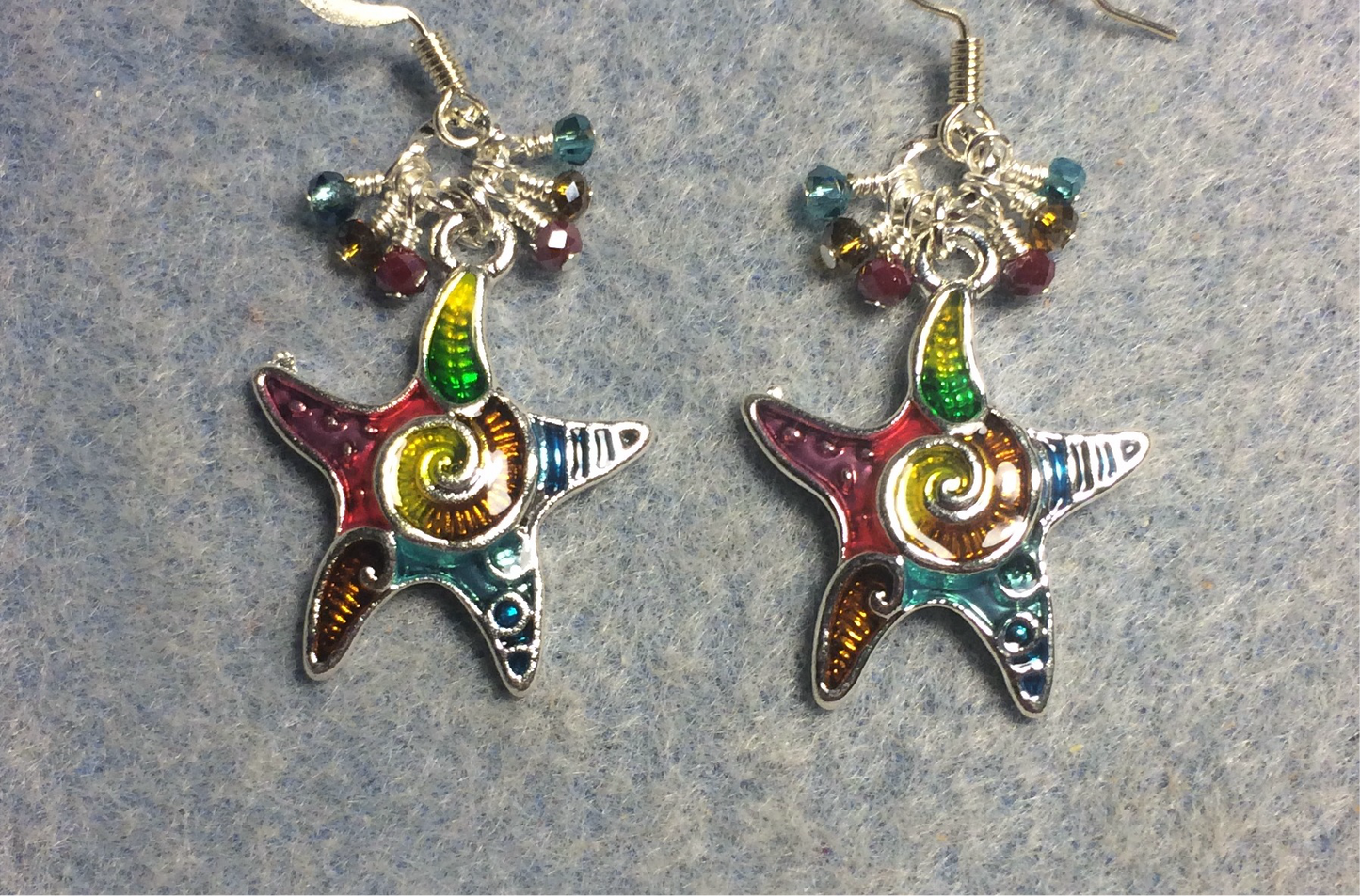 Colorful enamel starfish charm earrings adorned with tiny dangling purple, amber, and turquoise Chinese crystal beads.