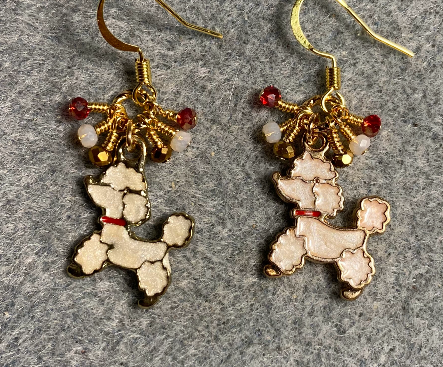White and red enamel poodle charm earrings adorned with tiny dangling white, red, and gold Chinese crystal beads.