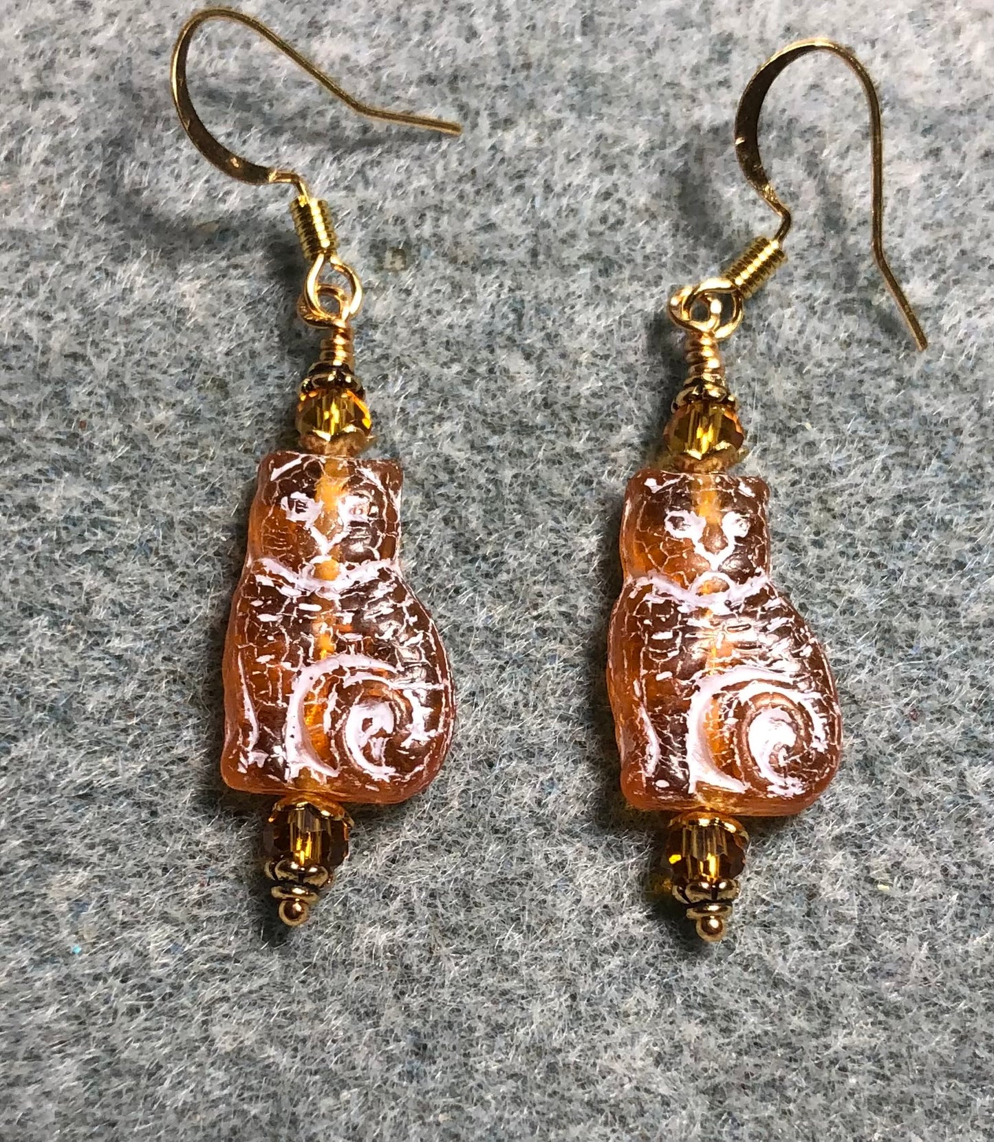 Medium amber (with white inlay) Czech glass cat bead earrings adorned with amber Chinese crystal beads.