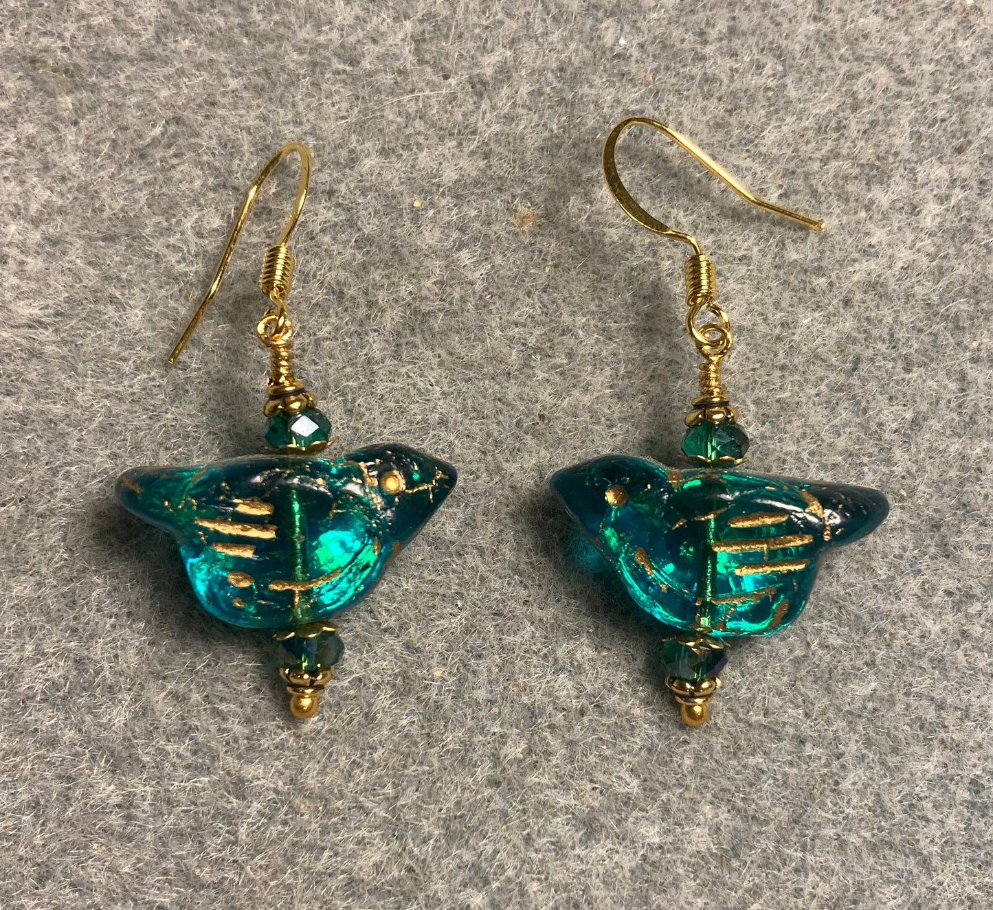Teal (with gold wash) Czech glass bird bead earrings adorned with teal Chinese crystal beads.