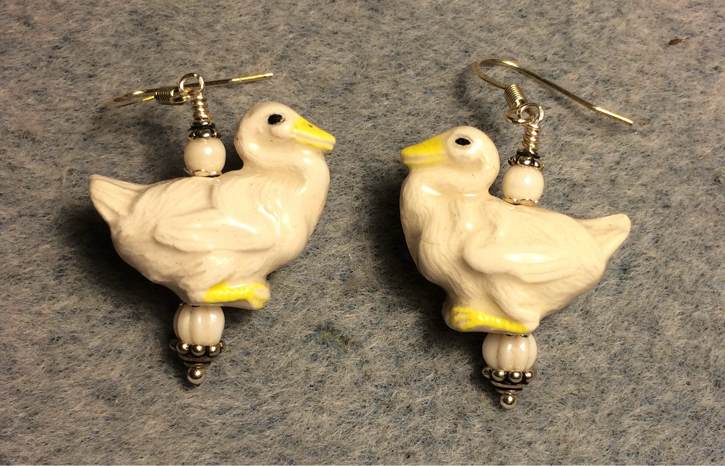 Off white ceramic goose bead earrings adorned with off white Czech glass beads.