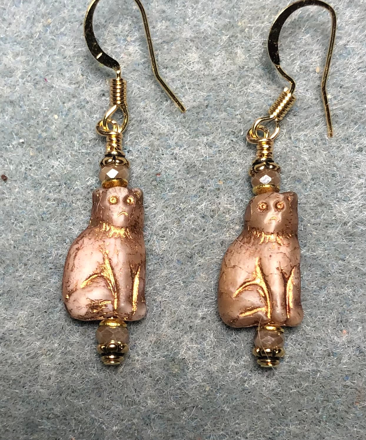 Small beige and gold Czech glass cat bead earrings adorned with beige Chinese crystal beads.