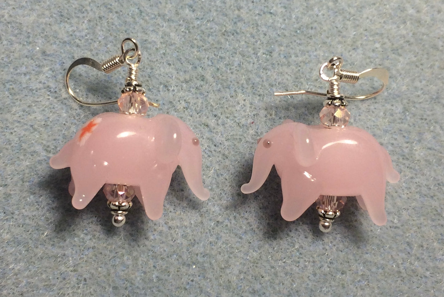Opaque pink lamp work elephant bead earrings adorned with pink Chinese crystal beads.