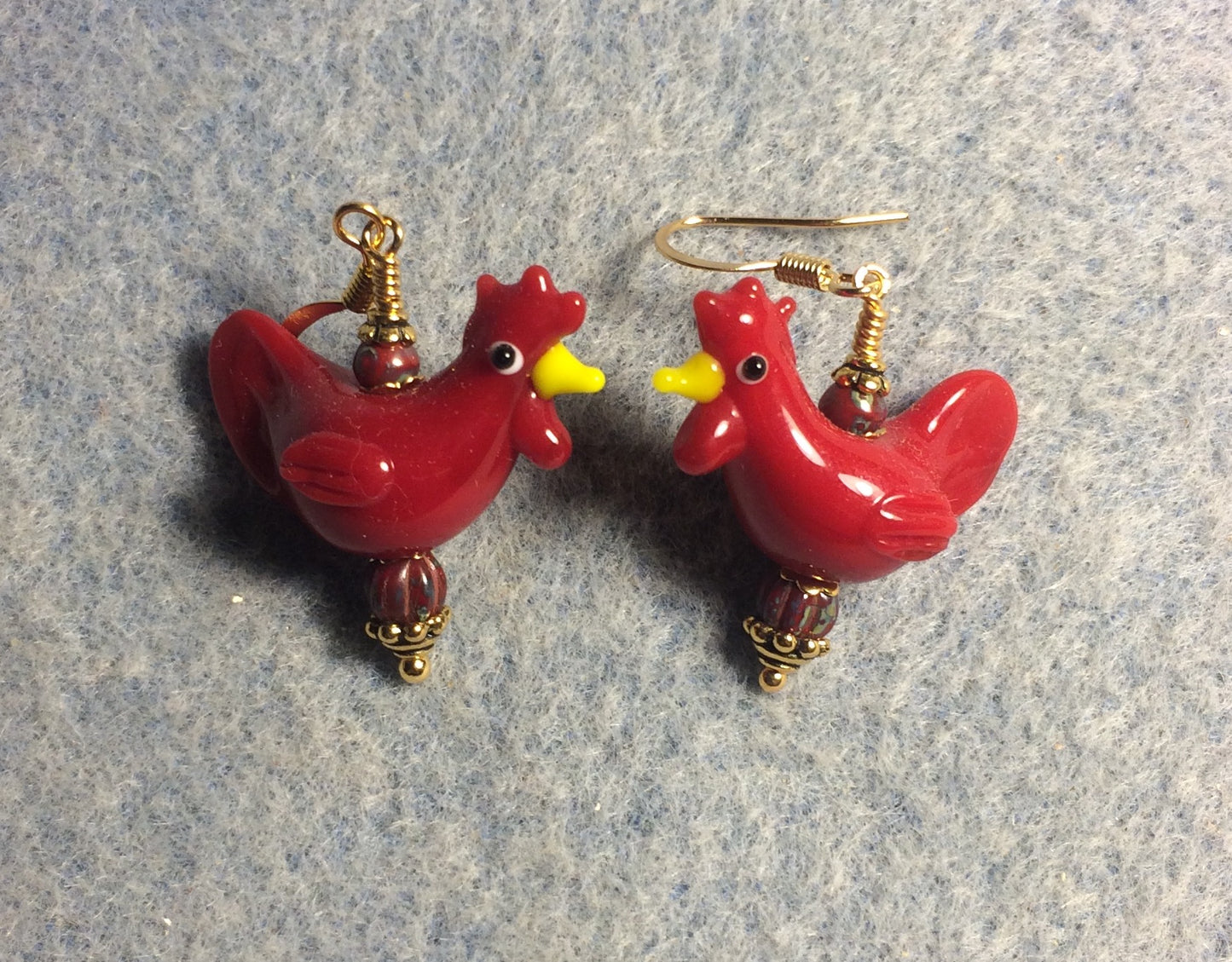 Bright red lamp work chicken bead earrings adorned with red Czech glass beads.
