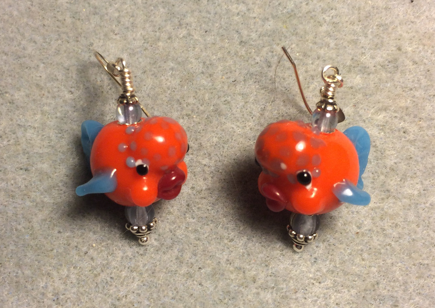 Orange and blue lamp work clownfish bead earrings adorned with light blue Czech glass beads.