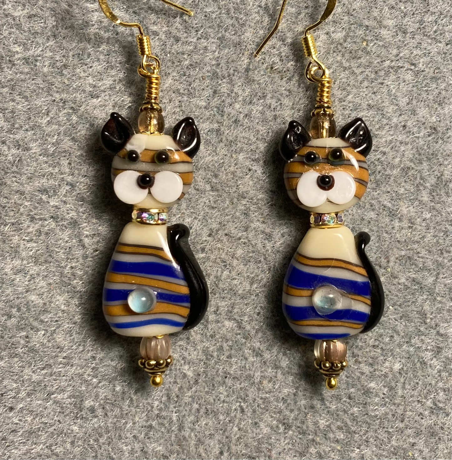 Brown and blue lamp work striped two piece cat bead earrings adorned with clear rhinestone “collars” and tan Czech glass beads.