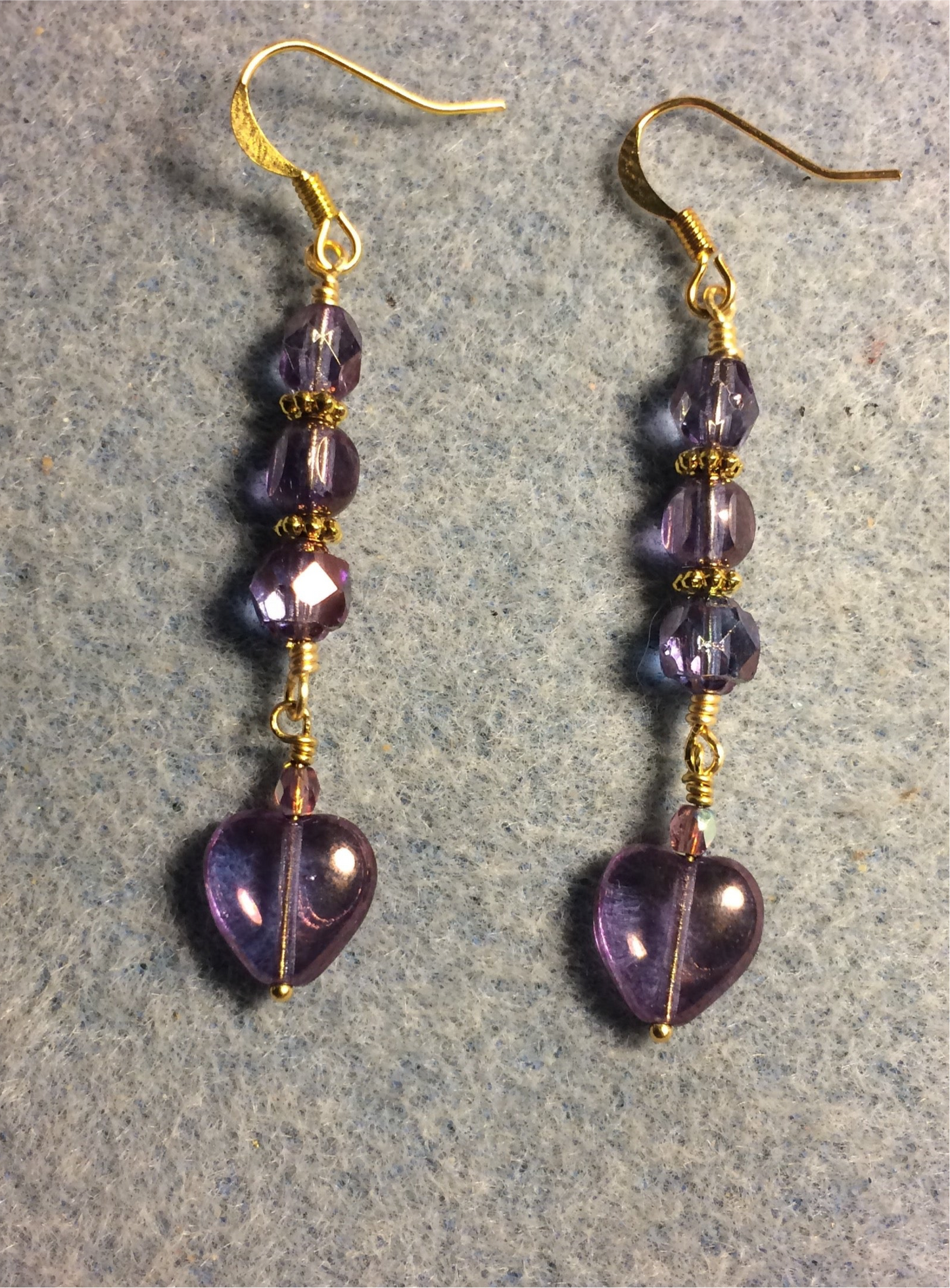 Small violet Czech glass heart bead earrings adorned with violet Czech glass beads.