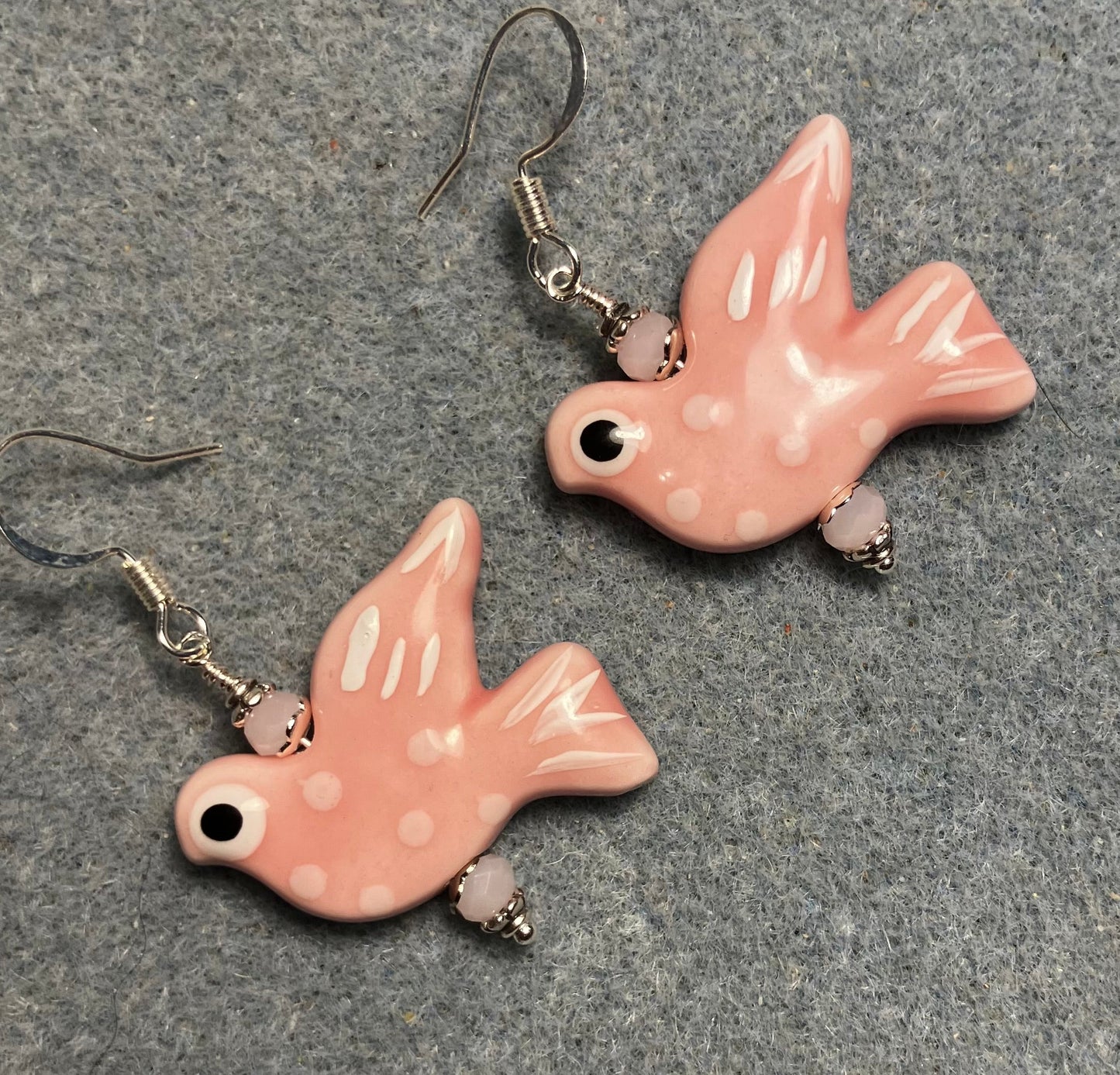 Large pink and white ceramic spotted dove bead earrings adorned with pink Chinese crystal beads.