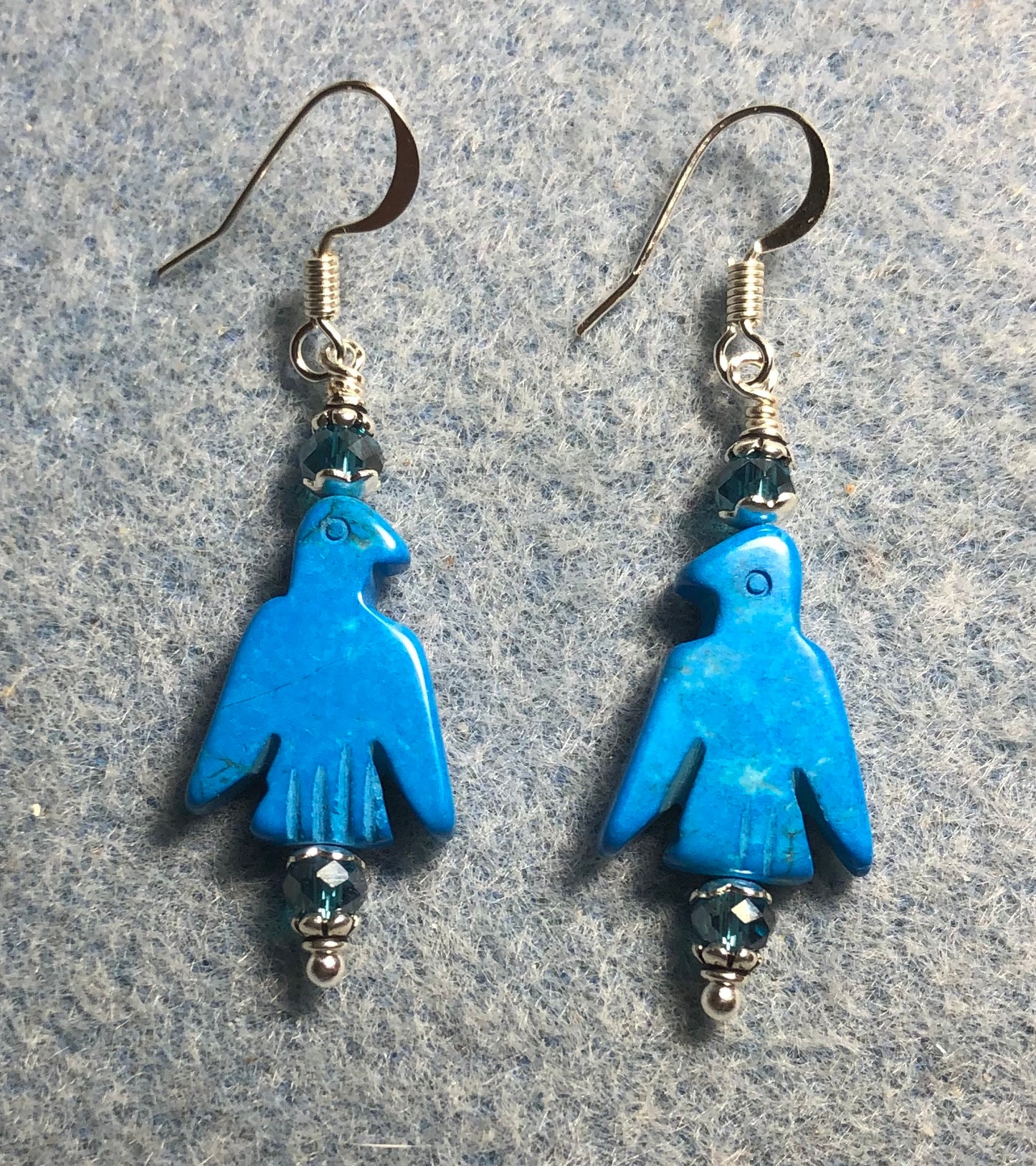 Turquoise howlite gemstone eagle bead earrings adorned with turquoise Chinese crystal beads.