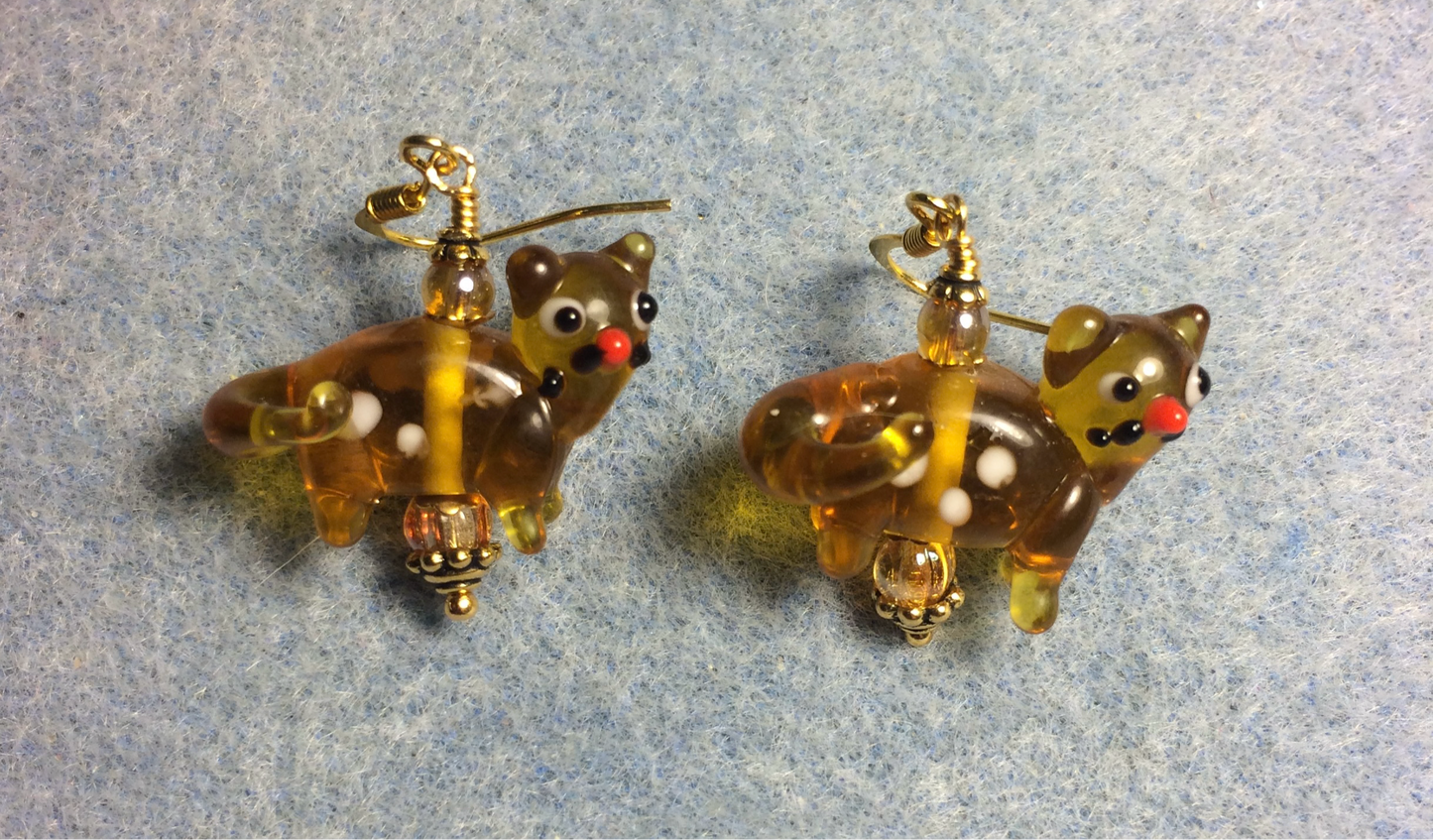Translucent amber lamp work spotted cat bead earrings adorned with amber Czech glass beads.