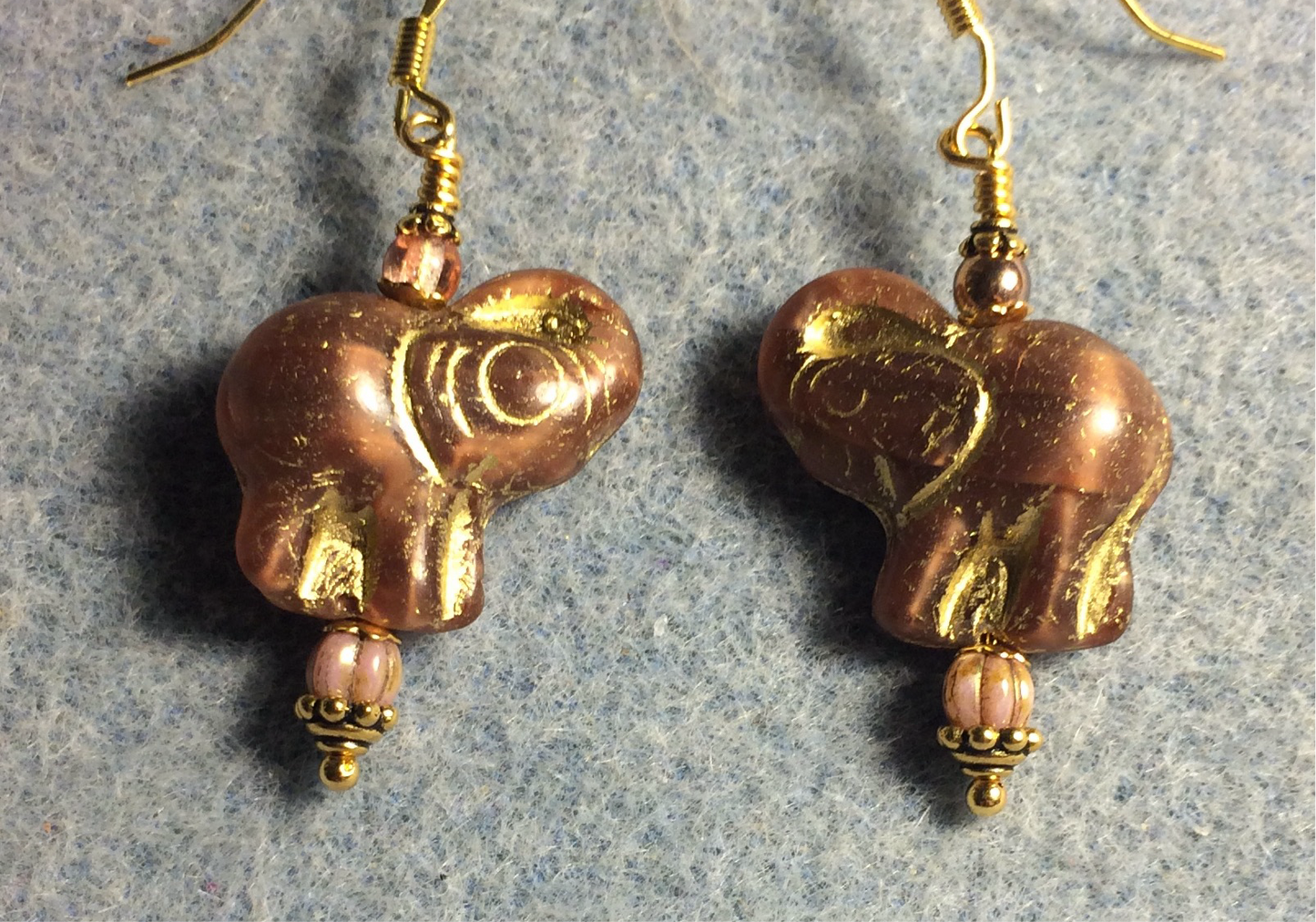 Rose gold (with gold inlay) Czech glass elephant bead earrings adorned with rose gold Czech glass beads.