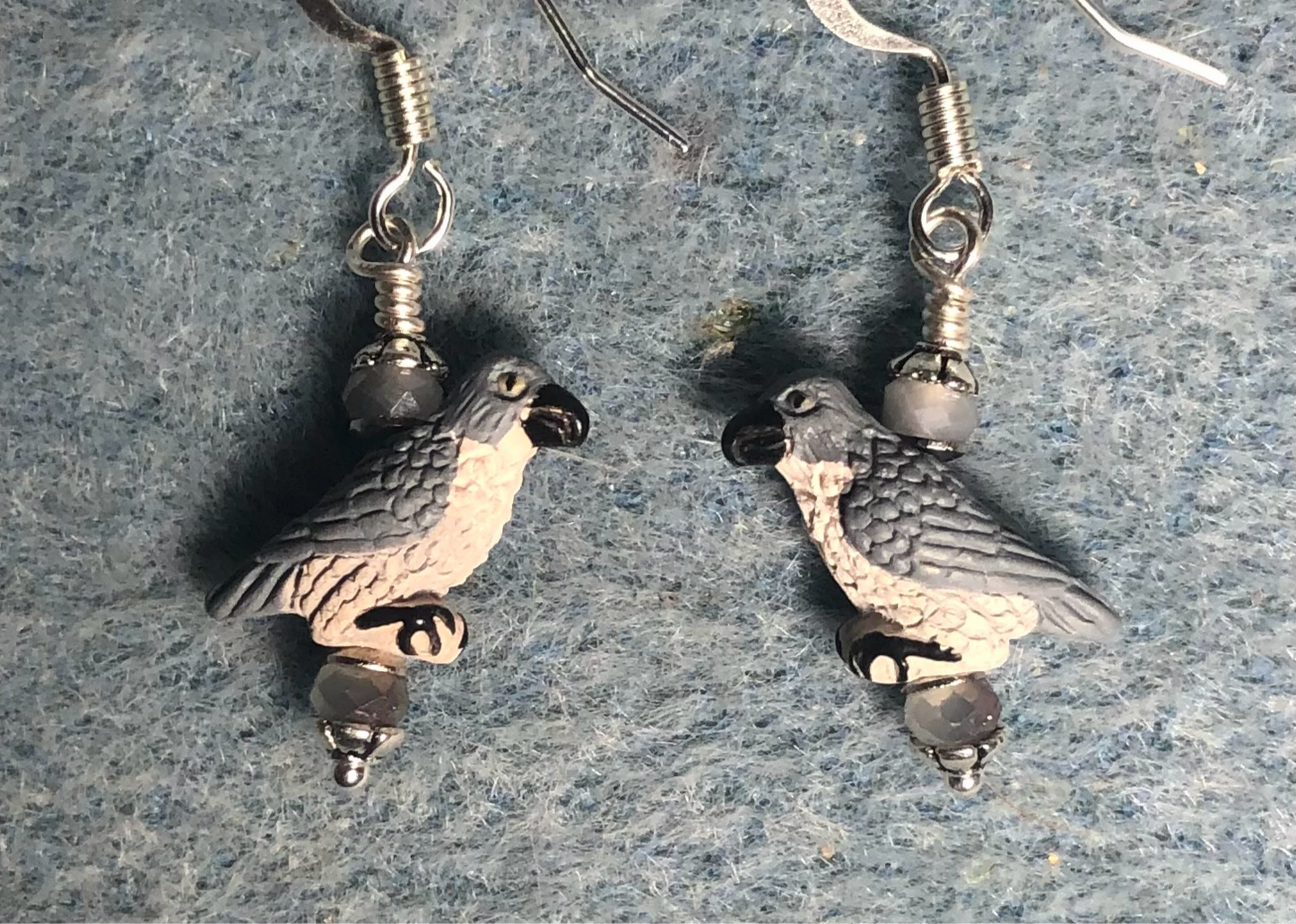 Small gray and black ceramic peregrine falcon bead earrings adorned with gray Chinese crystal beads.