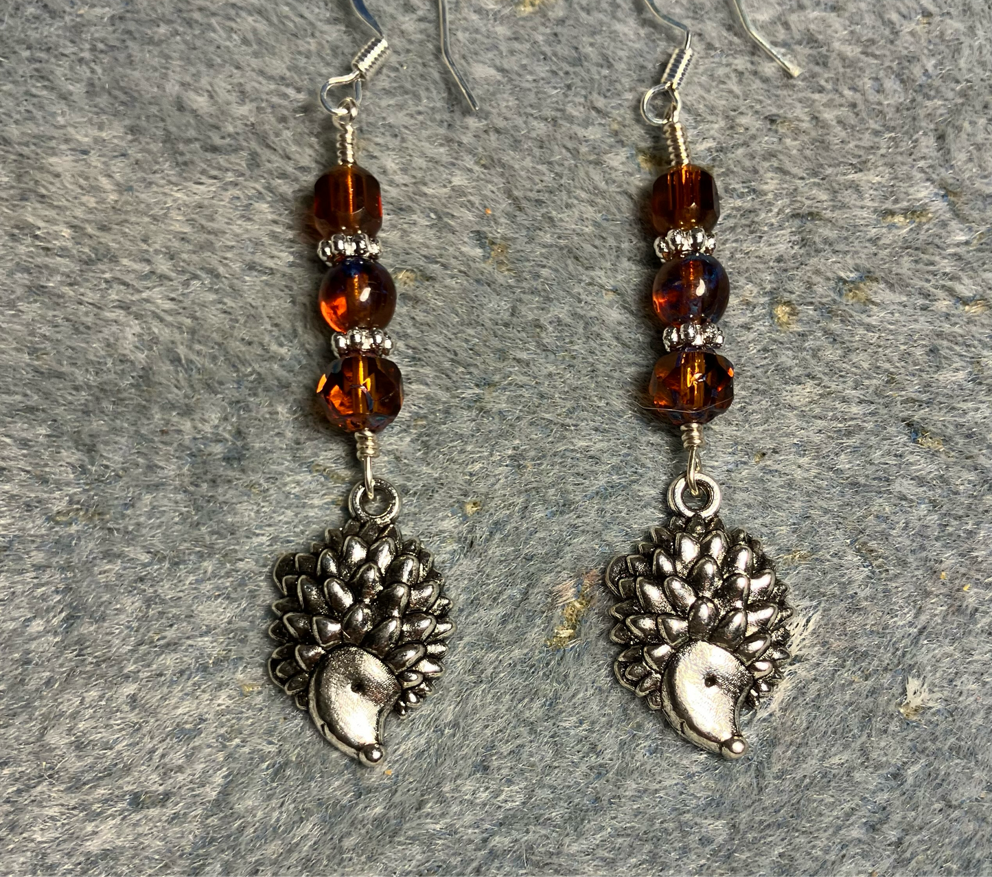 Silver hedgehog charm earrings adorned with topaz Czech glass beads