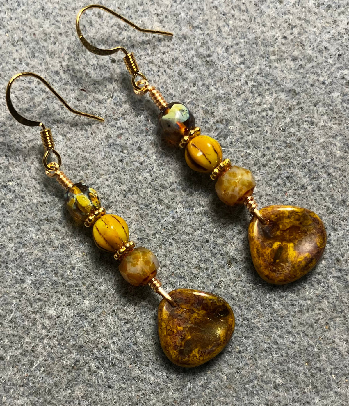 Yellow gold Picasso Czech glass rose petal earrings adorned with yellow Picasso Czech glass beads.