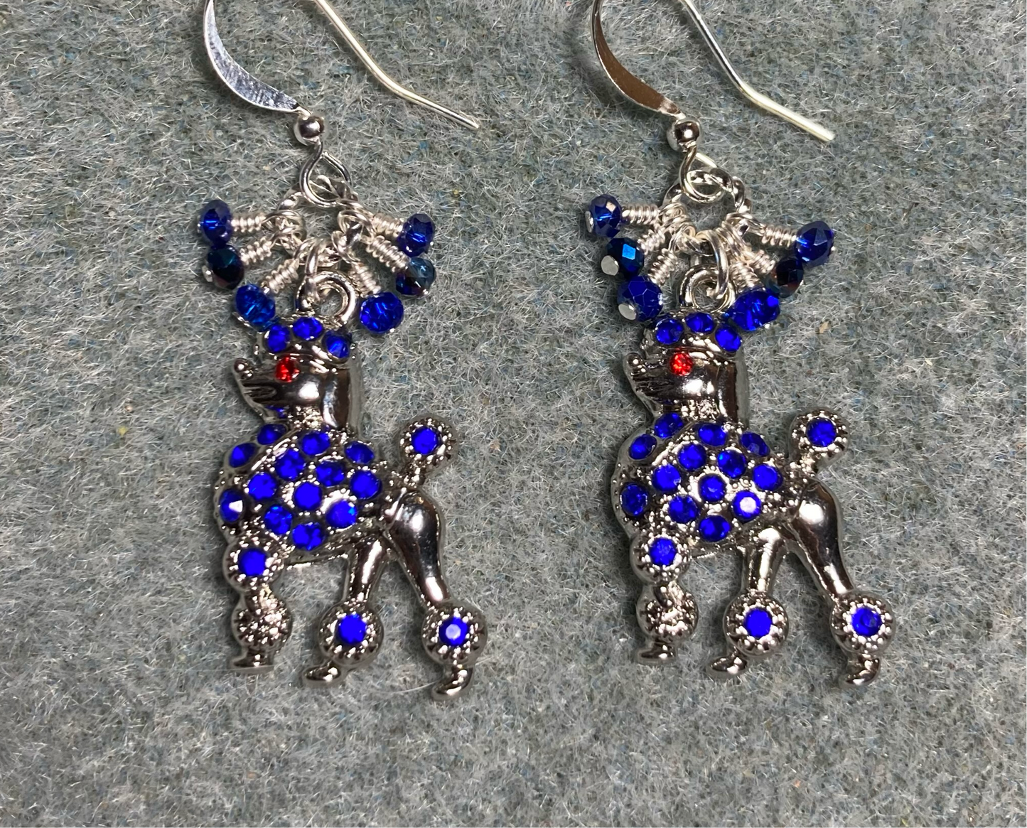Silver and dark blue rhinestone poodle charm earrings adorned with tiny dangling dark blue Chinese crystal beads.
