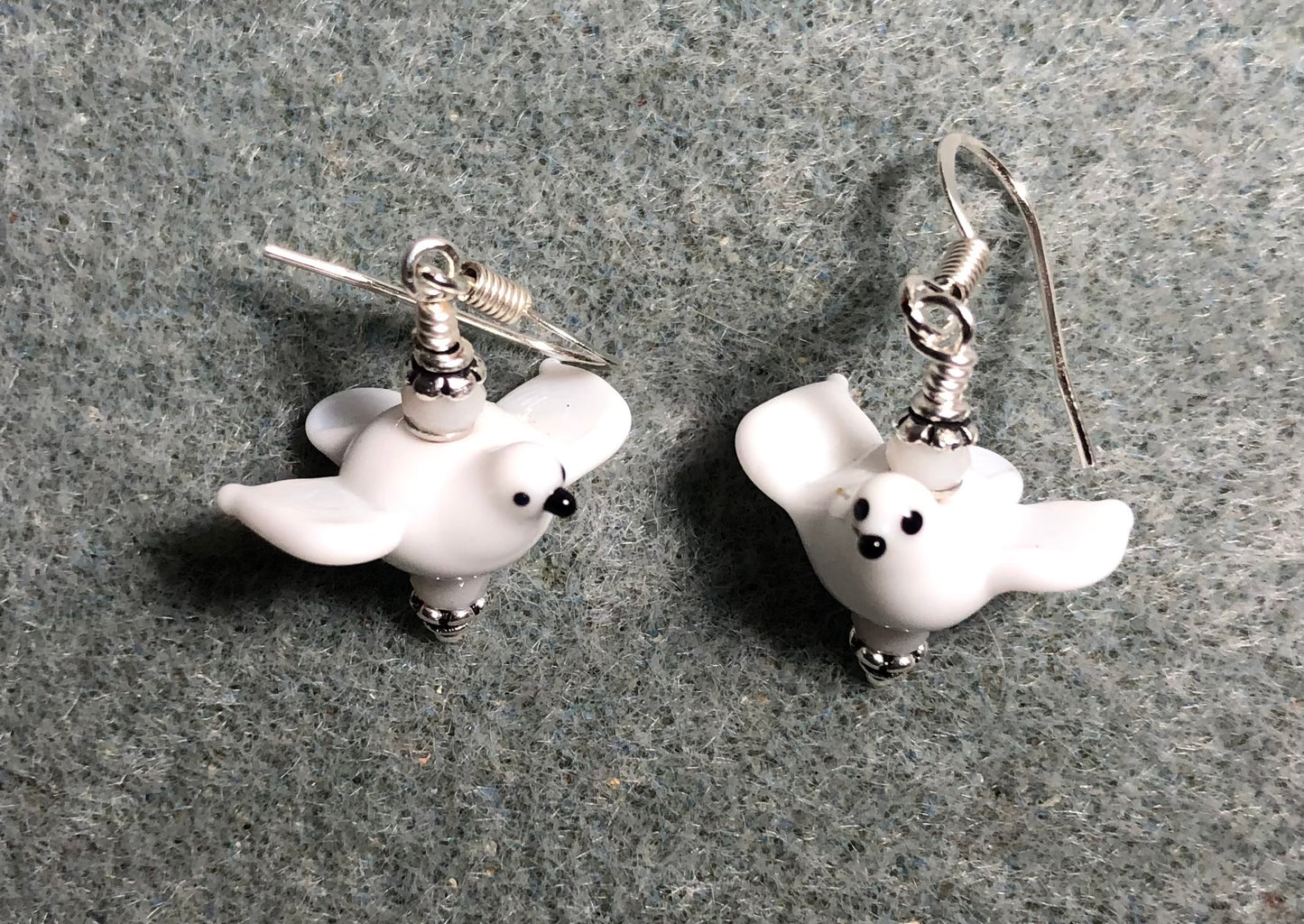 Small white lamp work flying dove bead earrings adorned with white Chinese crystal beads.