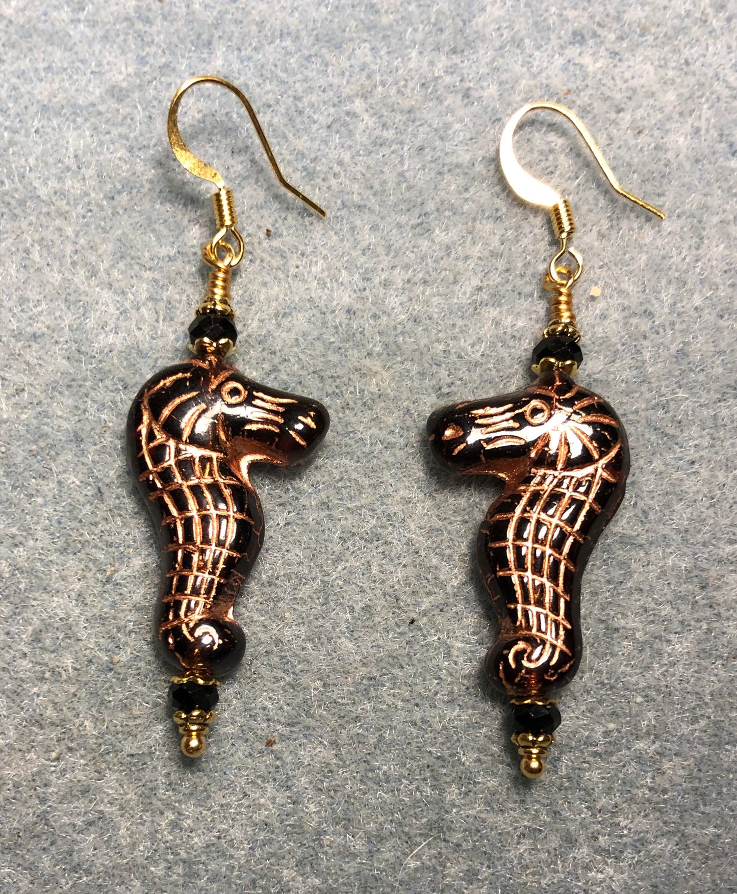 Black (with copper inlay) Czech glass seahorse bead earrings adorned with black Chinese crystal beads.