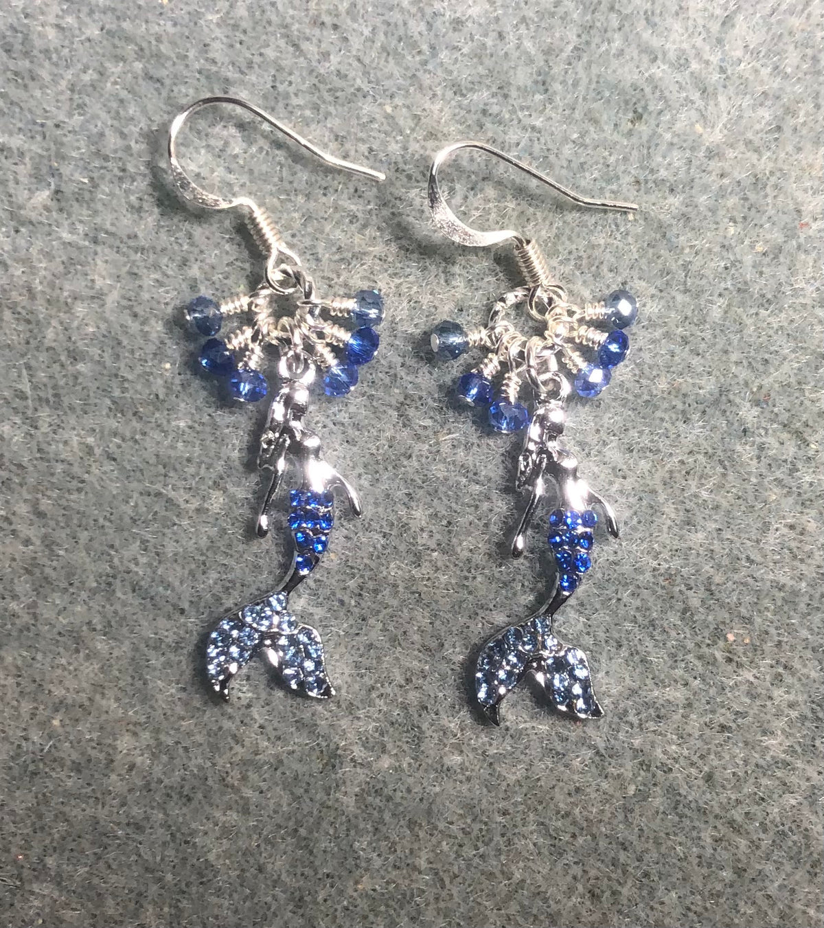 Silver, light blue, and dark blue rhinestone mermaid charm earrings adorned with tiny dangling light blue and dark blue Chinese crystal beads.