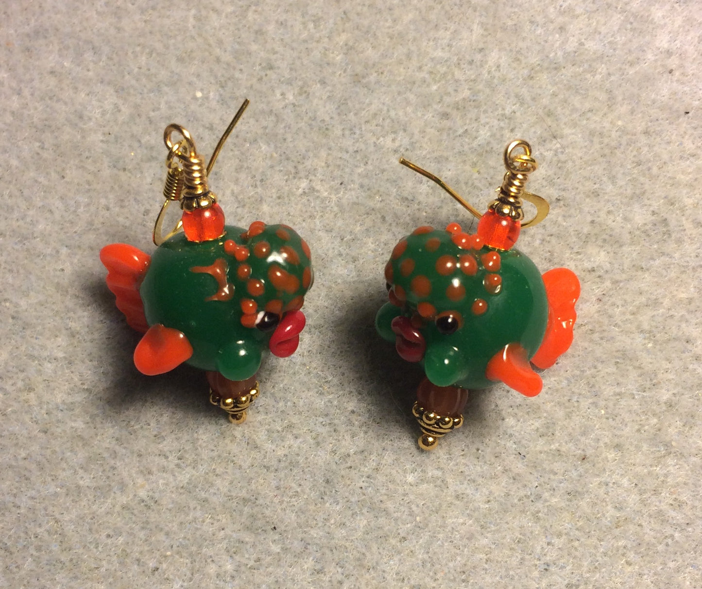 Dark green and orange lamp work clownfish bead earrings adorned with orange Czech glass beads.