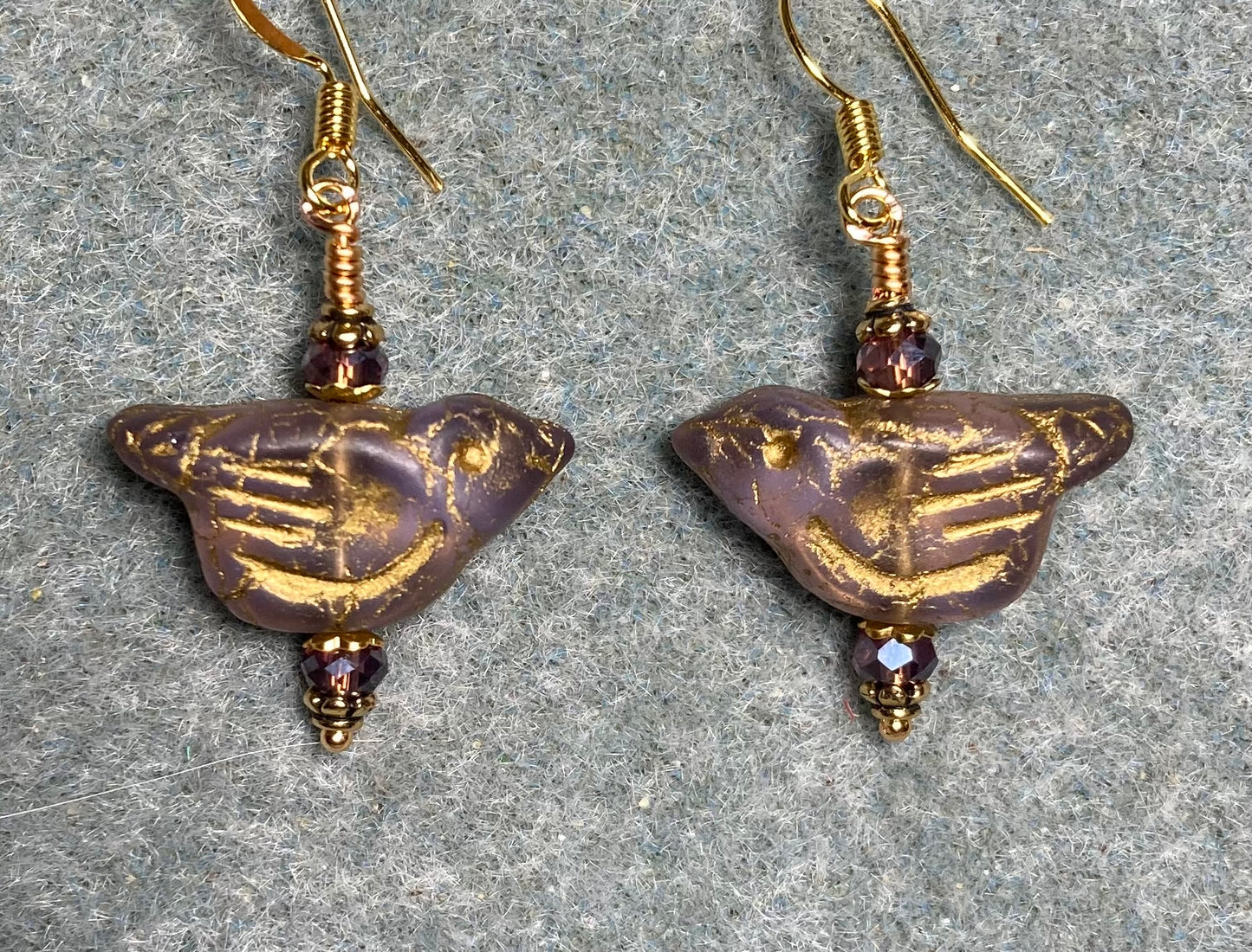 Translucent violet (with gold wash) Czech glass bird bead earrings adorned with violet Chinese crystal beads.