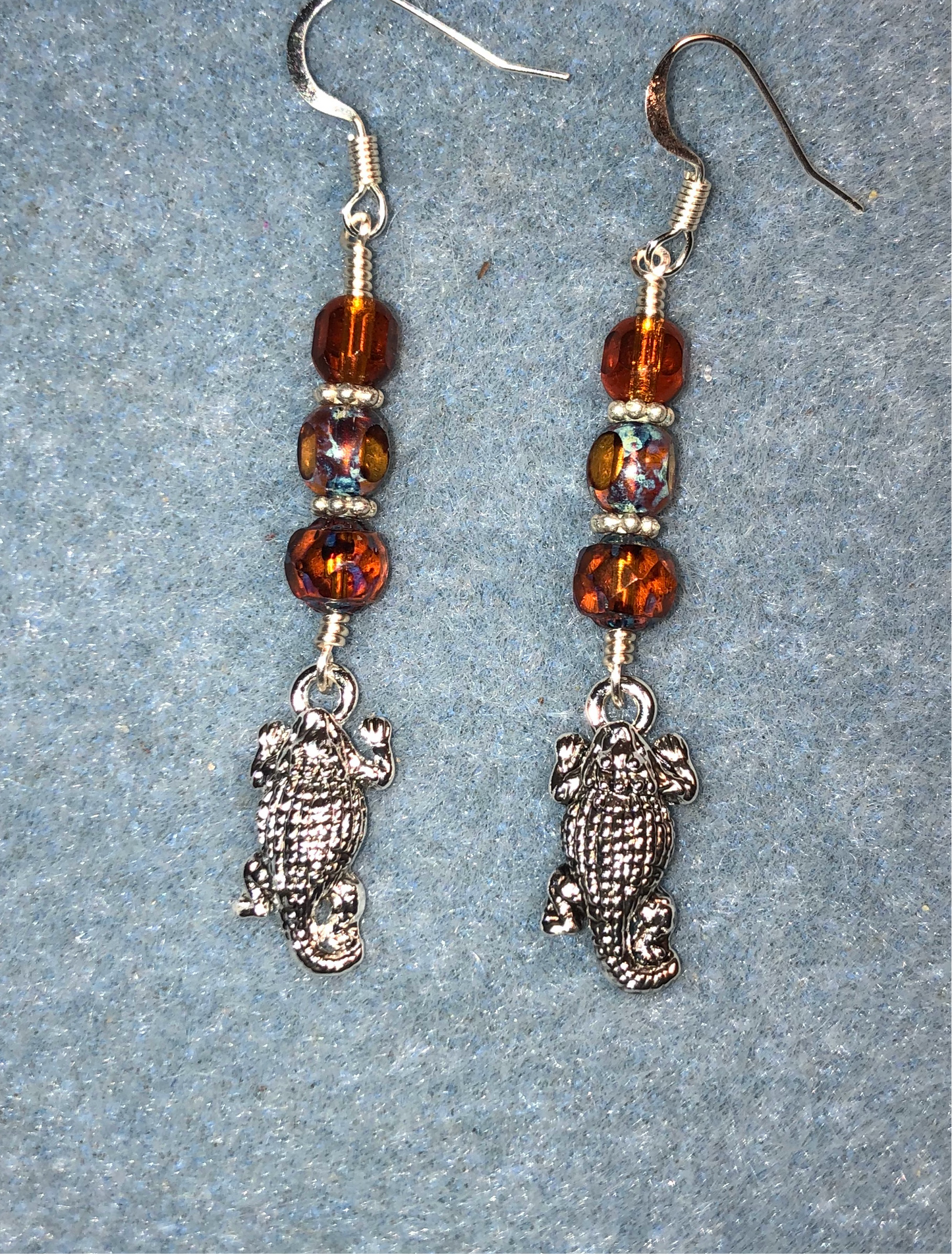 Silver horned lizard charm earrings adorned with topaz Czech glass beads
