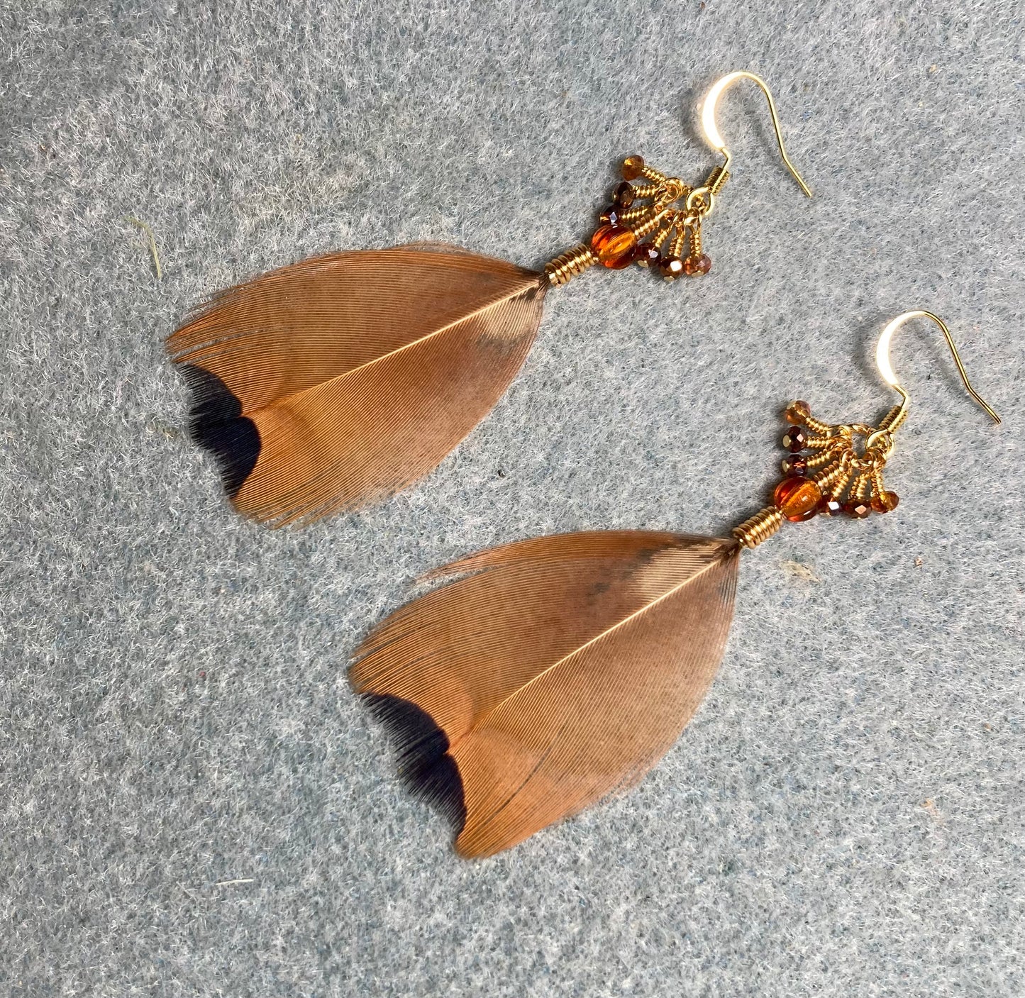 Brown and black pheasant feather earrings adorned with tiny gold and topaz Chinese crystal beads.