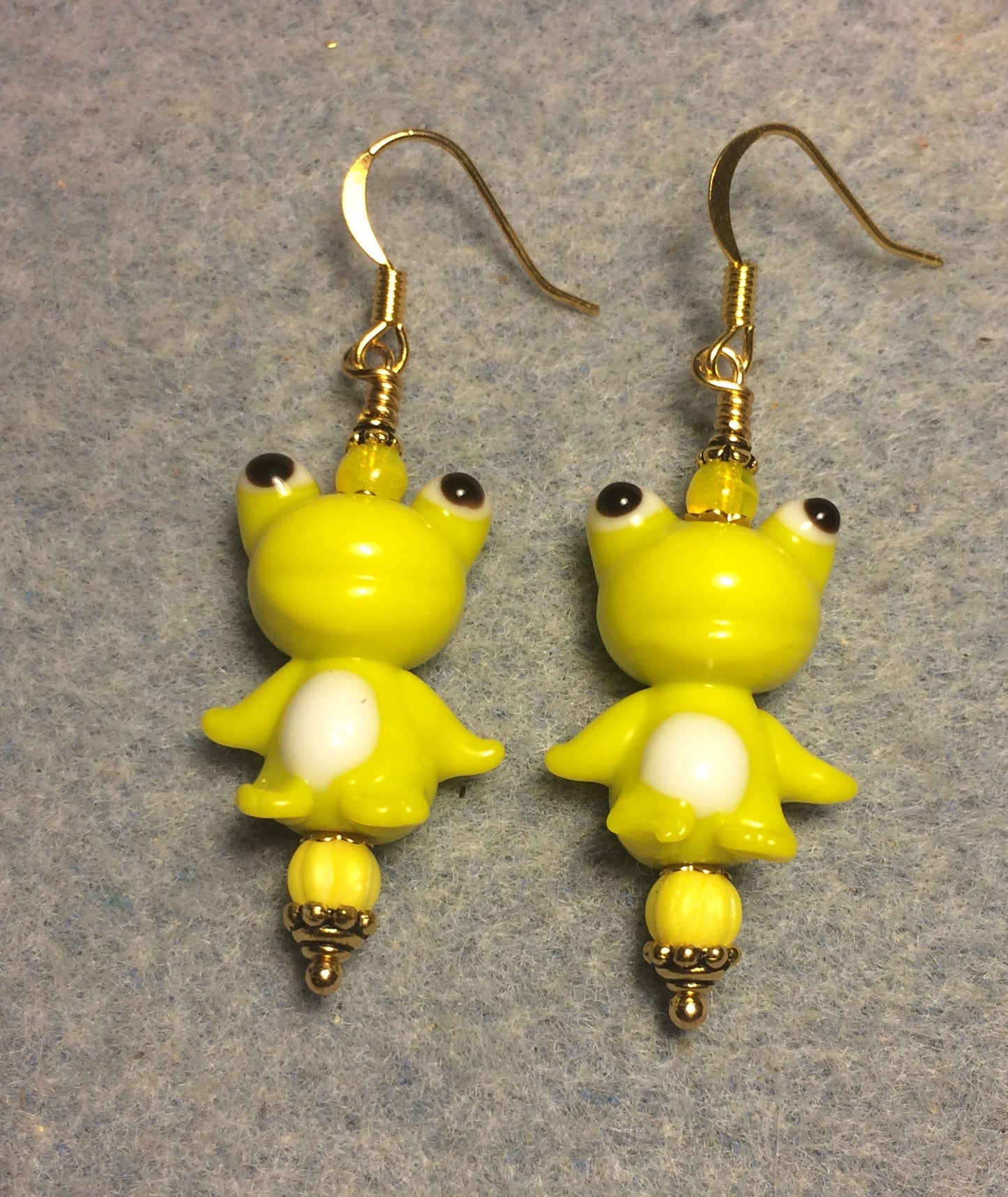 Greenish yellow lamp work silly frog bead earrings adorned with yellow Czech glass beads.