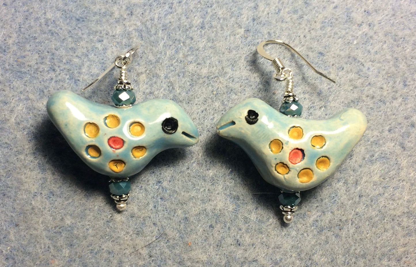 Medium aqua, yellow, and red ceramic songbird bead earrings adorned with aqua Czech glass beads.